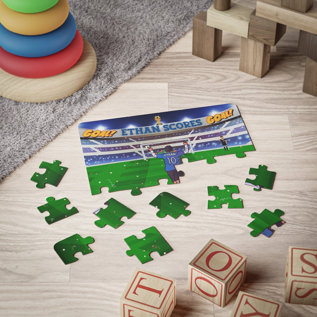 Personalized kids soccer jigsaw puzzle in progress on a playroom floor, showing a stadium goal scene with a custom name on the player’s jersey.