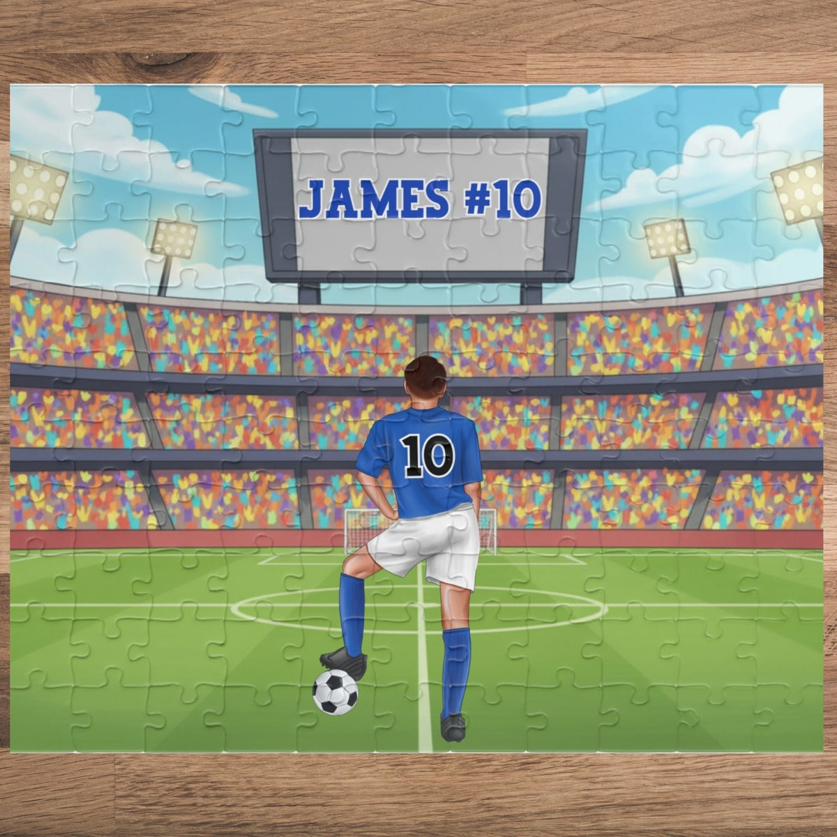 Personalized boys soccer jigsaw puzzle featuring a stadium scene with a customizable name and number displayed on the scoreboard and a customizable jersey number on the player’s back.