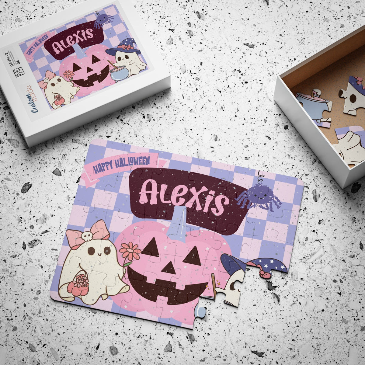 Custom name Halloween jigsaw puzzle for kids with the child’s name printed prominently across the top of the puzzle design, featuring a spooky-cute ghost and pumpkin scene shown with the puzzle box.