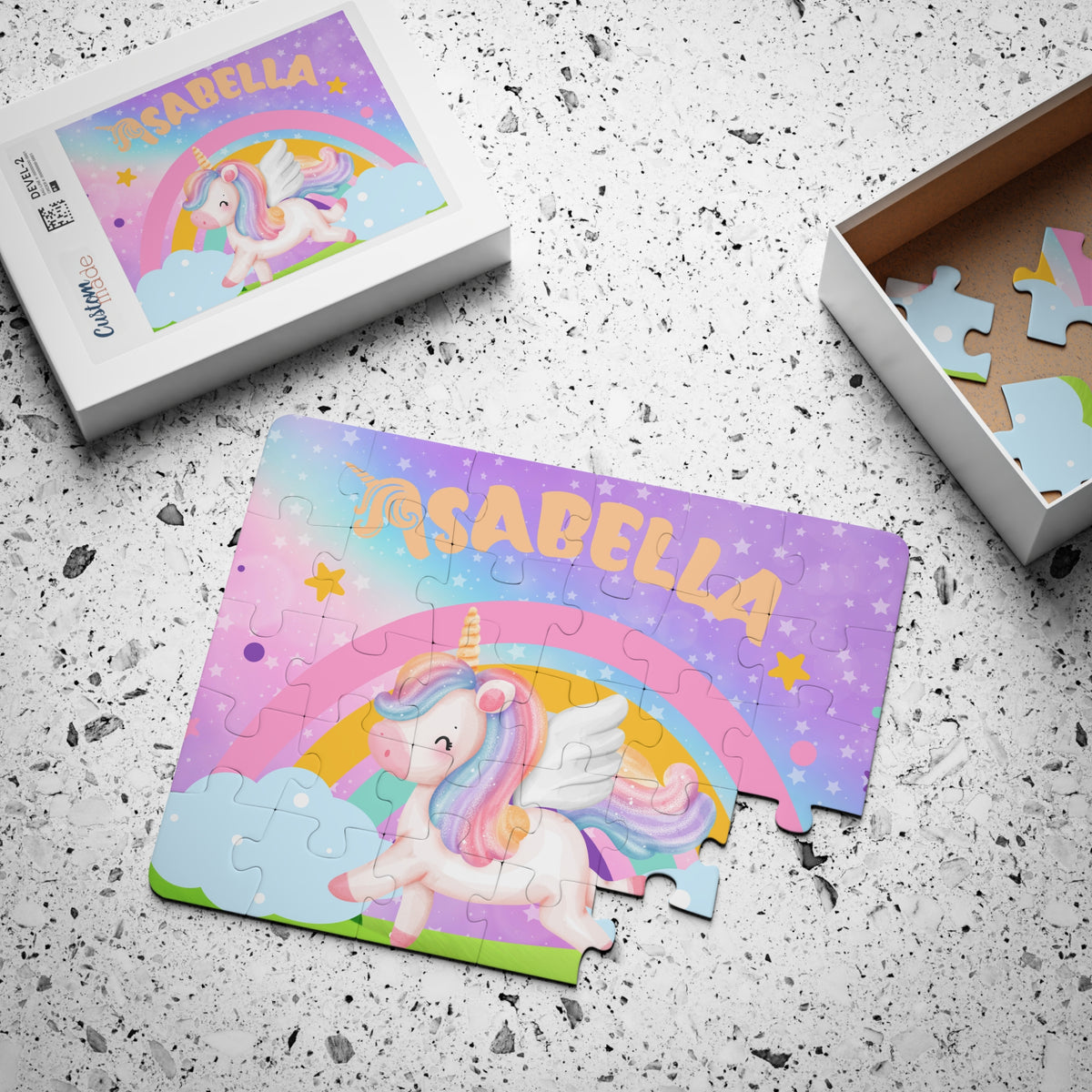 Personalized unicorn kids jigsaw puzzle with a customizable name shown on the puzzle and matching box lid, featuring a rainbow and pastel unicorn design.