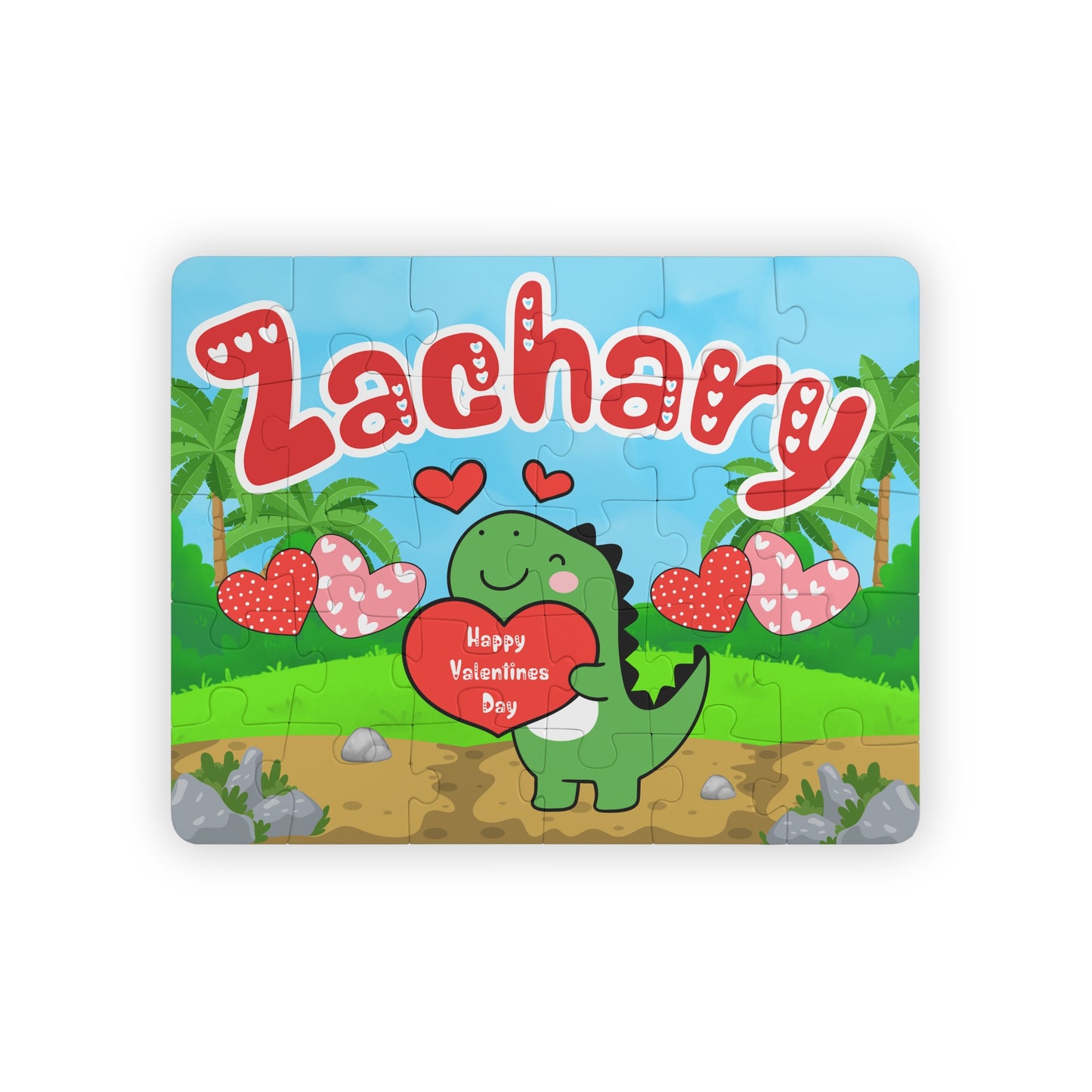 Personalized dinosaur name puzzle for kids featuring a cute green dino holding a heart that says “Happy Valentine’s Day,” surrounded by hearts and palm trees. The child’s name is customizable and appears large across the top of the puzzle (shown as “Zachary”), making this a custom 30-piece jigsaw designed for toddlers and young children.