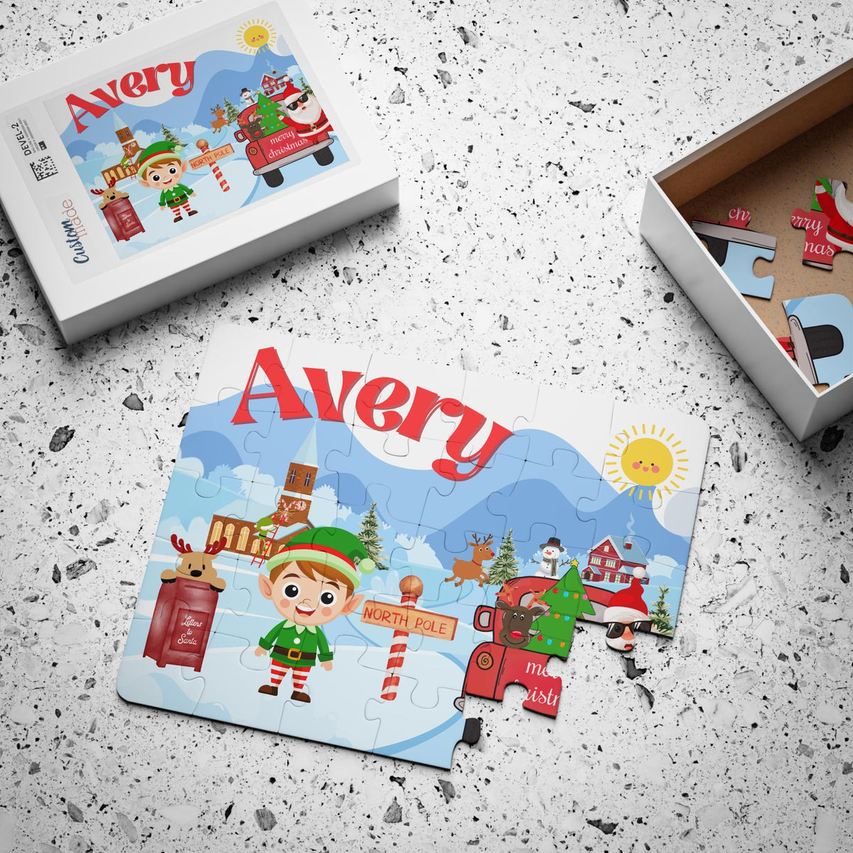 Personalized kids Christmas jigsaw puzzle packaged in a gift box, featuring a North Pole village illustration and a customizable name printed on the puzzle design.