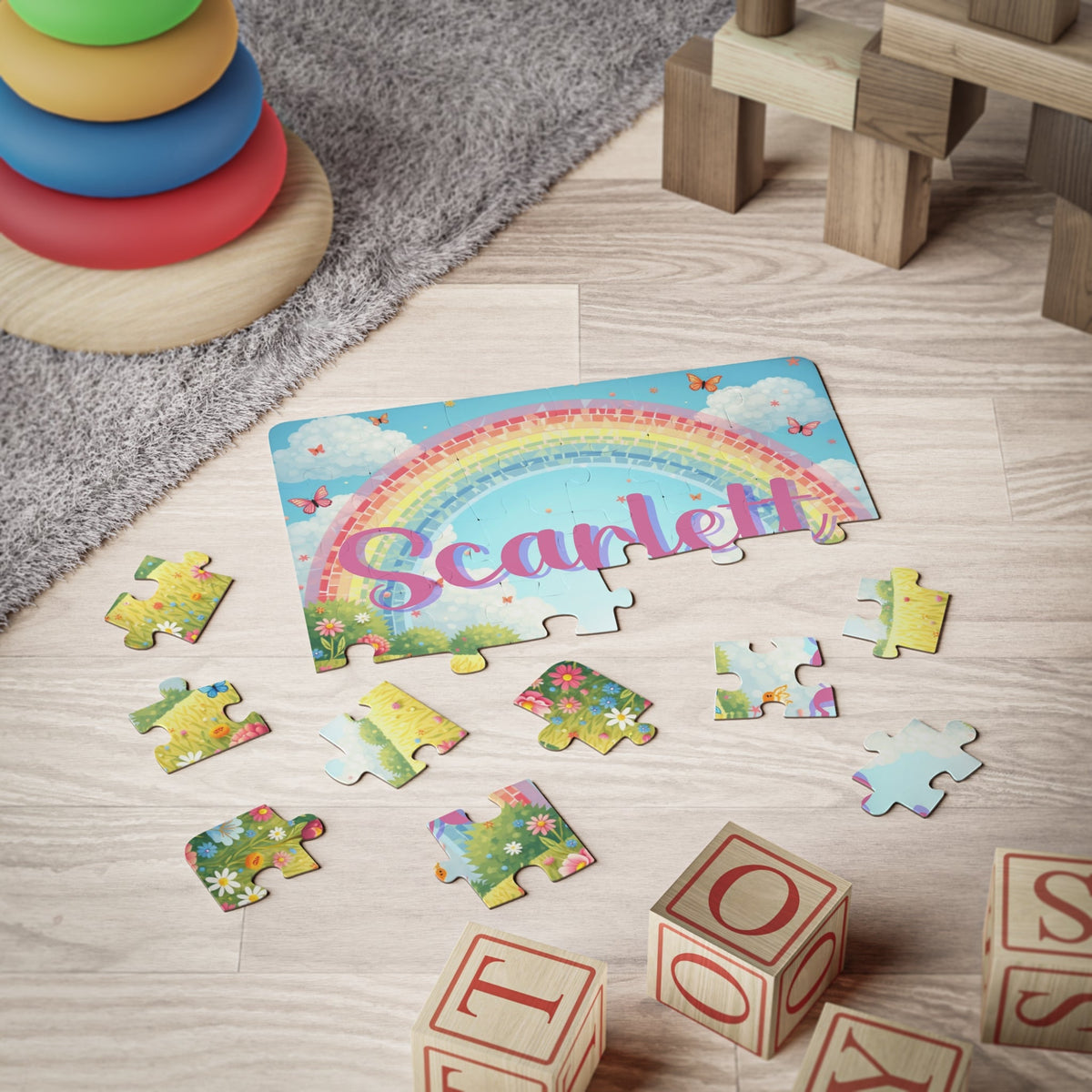 Personalized butterfly and rainbow jigsaw puzzle for kids shown during play, with large puzzle pieces and a customizable name printed across the puzzle design.