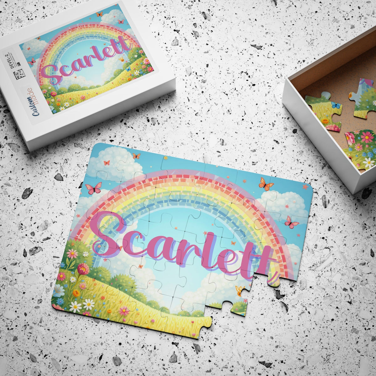 Personalized children’s name puzzle with butterfly and rainbow artwork shown with gift box, featuring a custom name printed prominently across the front of the 30-piece puzzle.