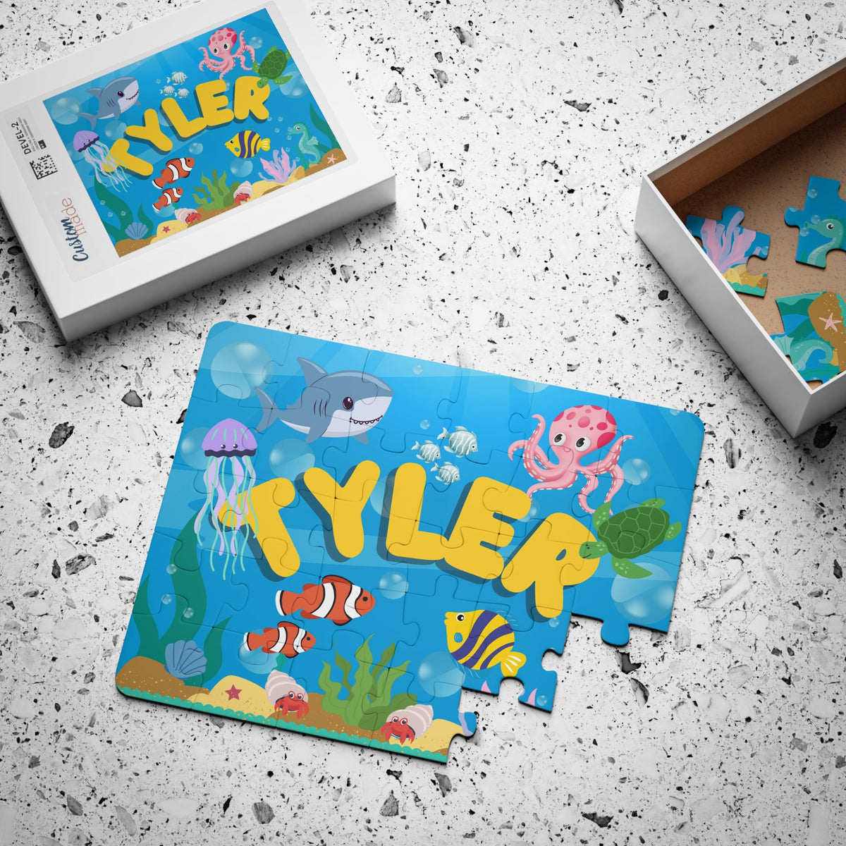 Personalized underwater name puzzle for kids packaged in a gift-ready box, featuring a colorful ocean scene with fish, octopus, and sea animals