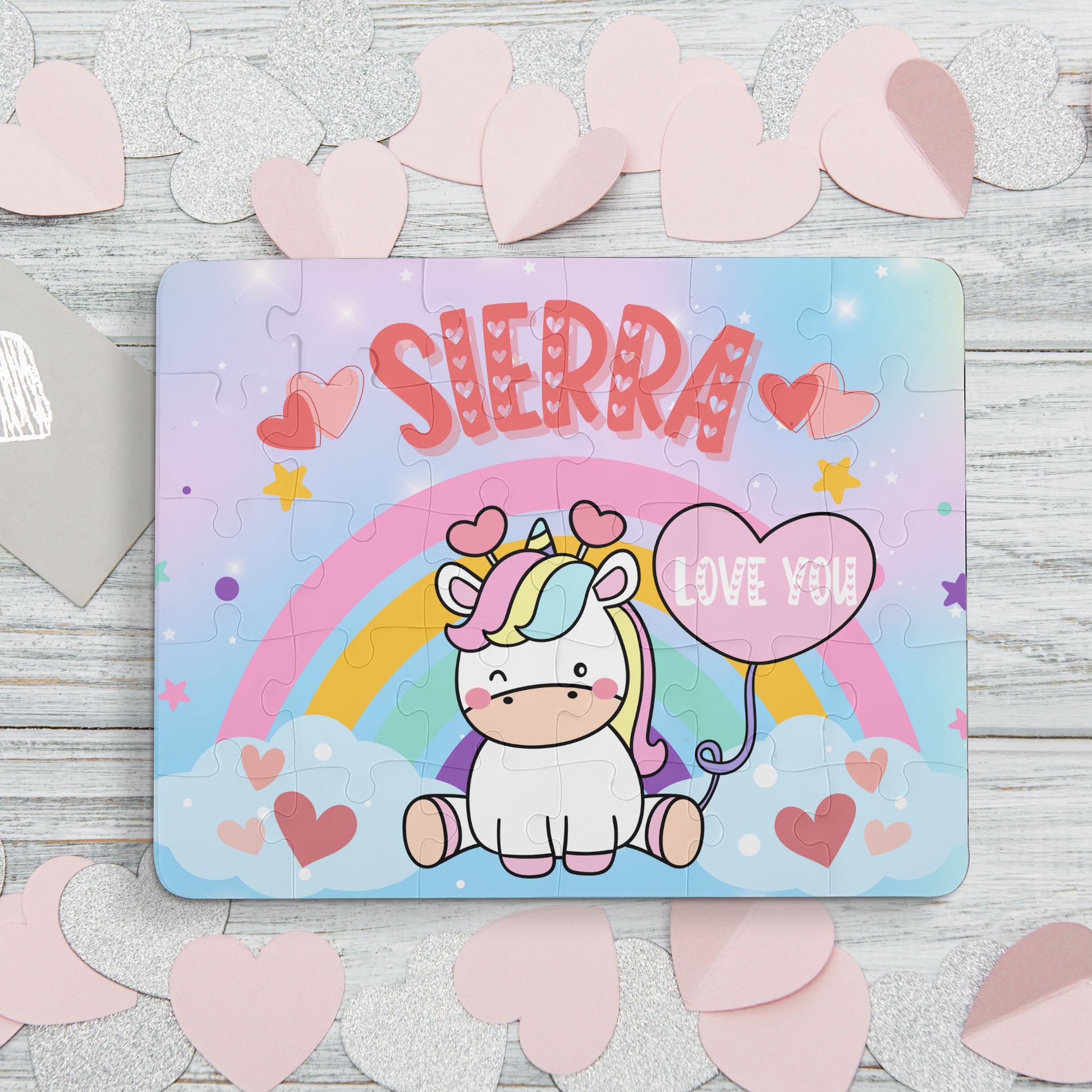 Cute personalized 30 piece unicorn puzzle for kids. Features a unicorn sitting in front of a rainbow holding a balloon that "Love You" This jigsaw puzzle is personalized with Name making it a fun and special gift