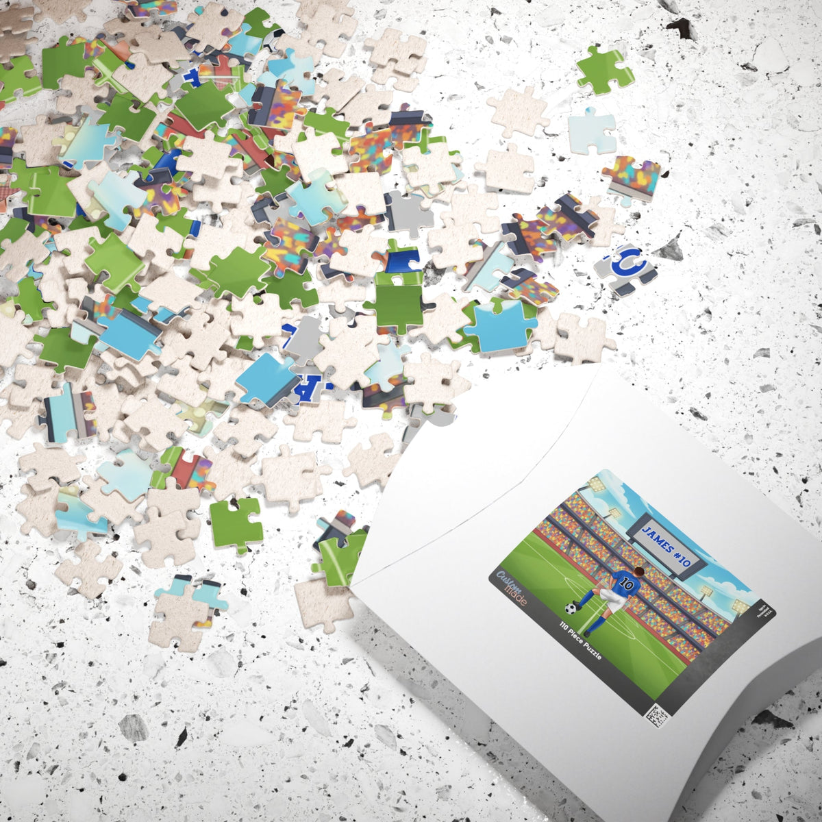 Close-up of scattered jigsaw pieces from a personalized boys soccer puzzle, showing parts of a stadium scene and a player with a customizable name and number.