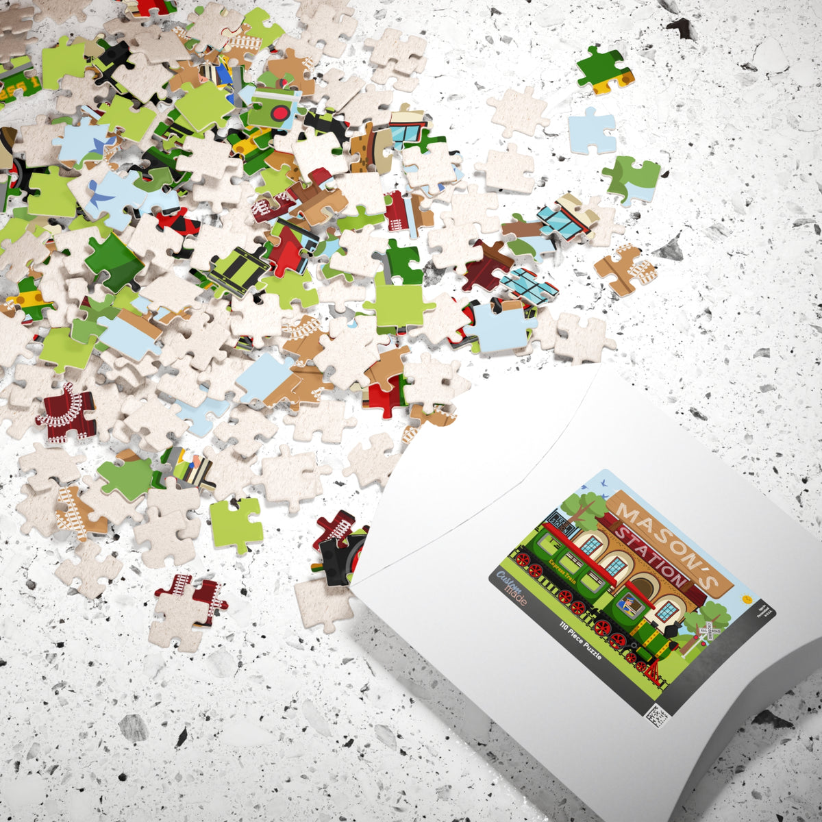 Personalized train station name puzzle shown with puzzle pieces and box, featuring a customizable name on the design
