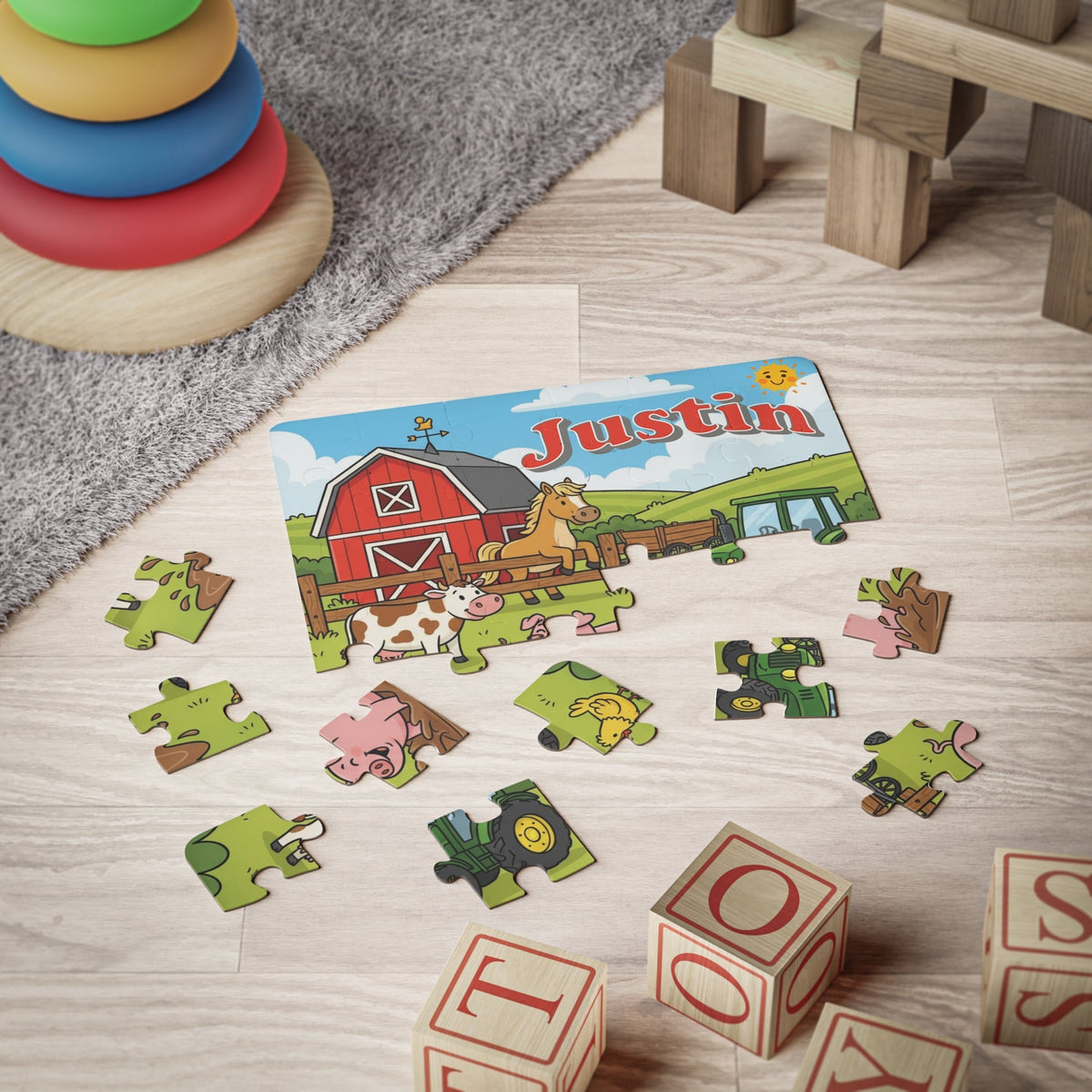 Personalized farm-themed jigsaw puzzle for kids shown partially assembled on a playroom floor with scattered jigsaw pieces. The child’s name is customizable and appears across the top of the puzzle.