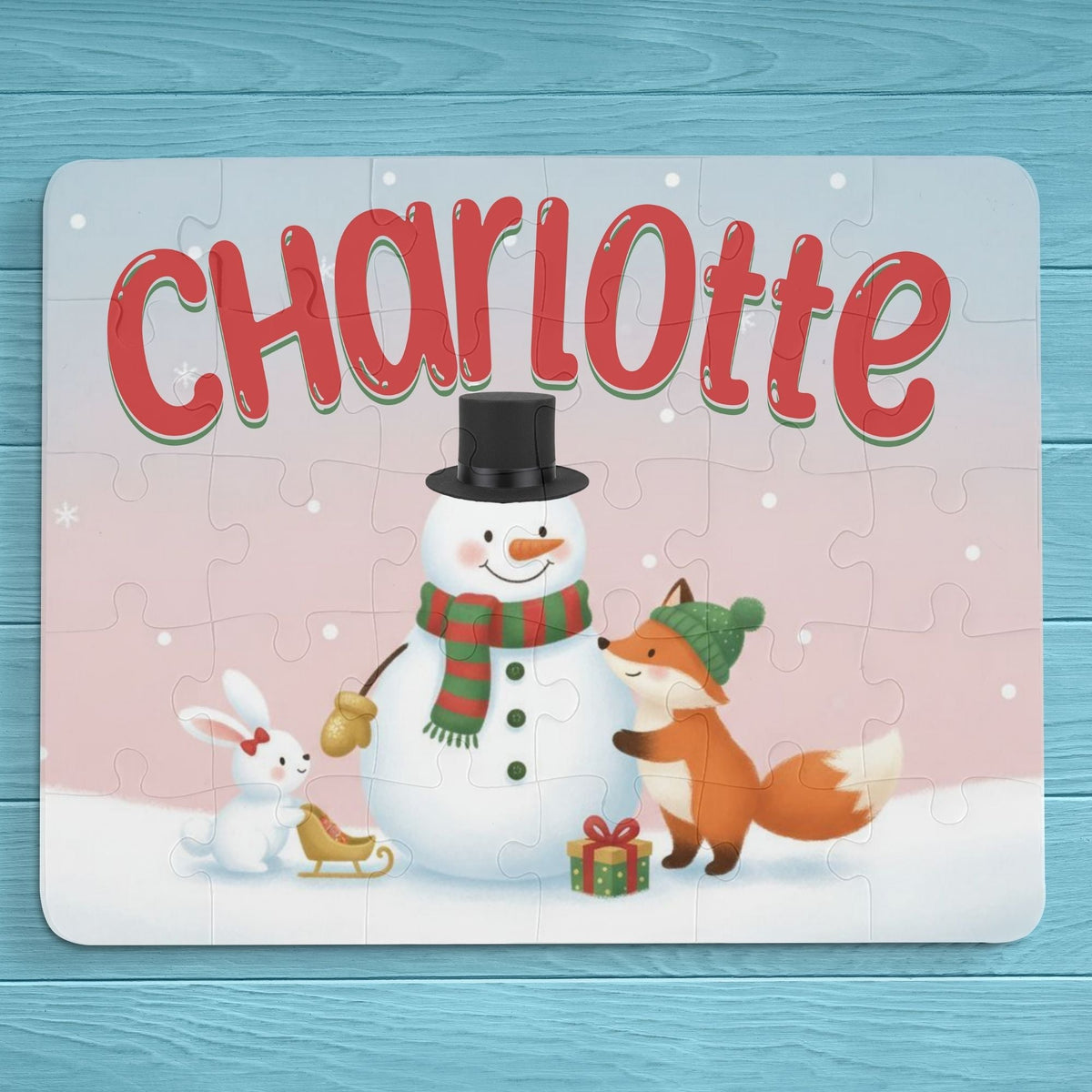 Personalized 30-piece kids puzzle featuring a winter snowman scene with a snowman, fox, and bunny, customized with the child’s name printed across the top of the puzzle.
