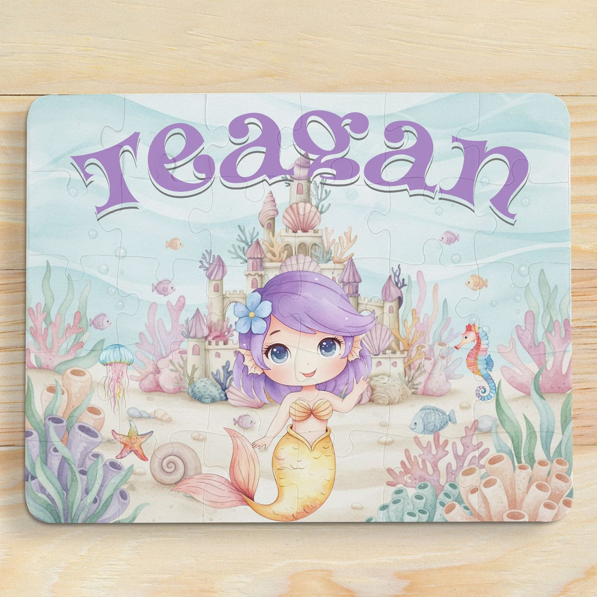 Personalized mermaid puzzle for kids featuring a smiling mermaid in an underwater castle scene with coral, shells, and sea creatures, customized with the child’s name displayed across the top