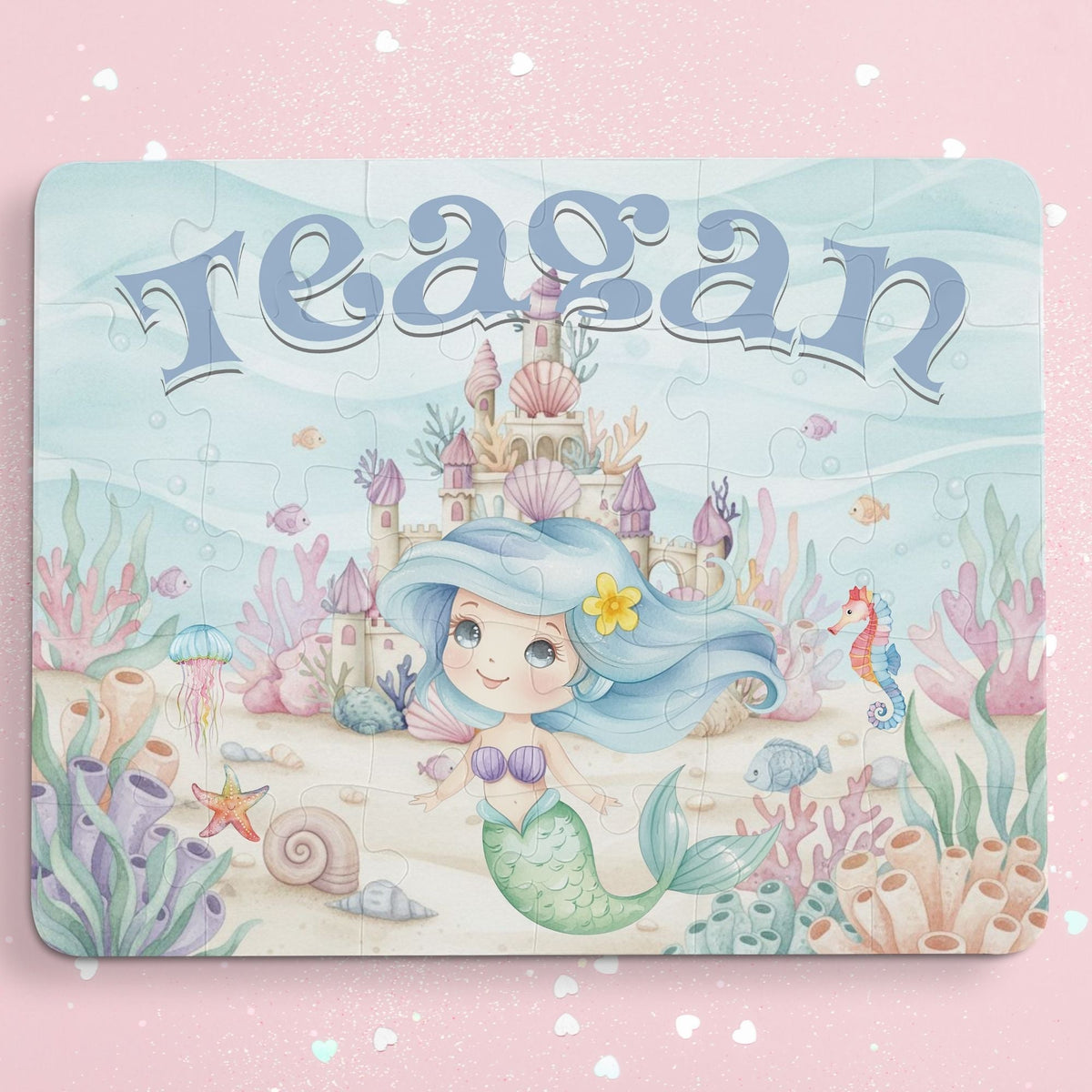 Personalized mermaid puzzle for kids featuring a smiling mermaid in an underwater castle scene with coral, shells, and sea creatures, customized with the child’s name displayed across the top