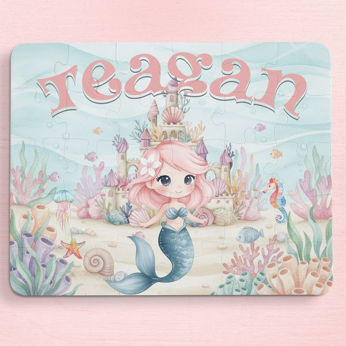 Personalized mermaid puzzle for kids featuring a smiling mermaid in an underwater castle scene with coral, shells, and sea creatures, customized with the child’s name displayed across the top