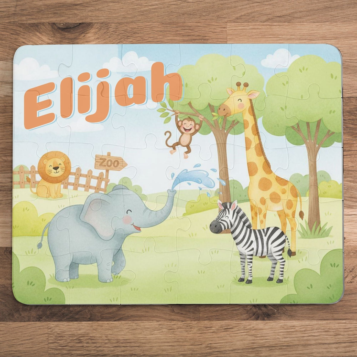 Personalized zoo animal kids puzzle featuring a customizable name at the top, with a cute elephant, giraffe, zebra, lion, and monkey scene