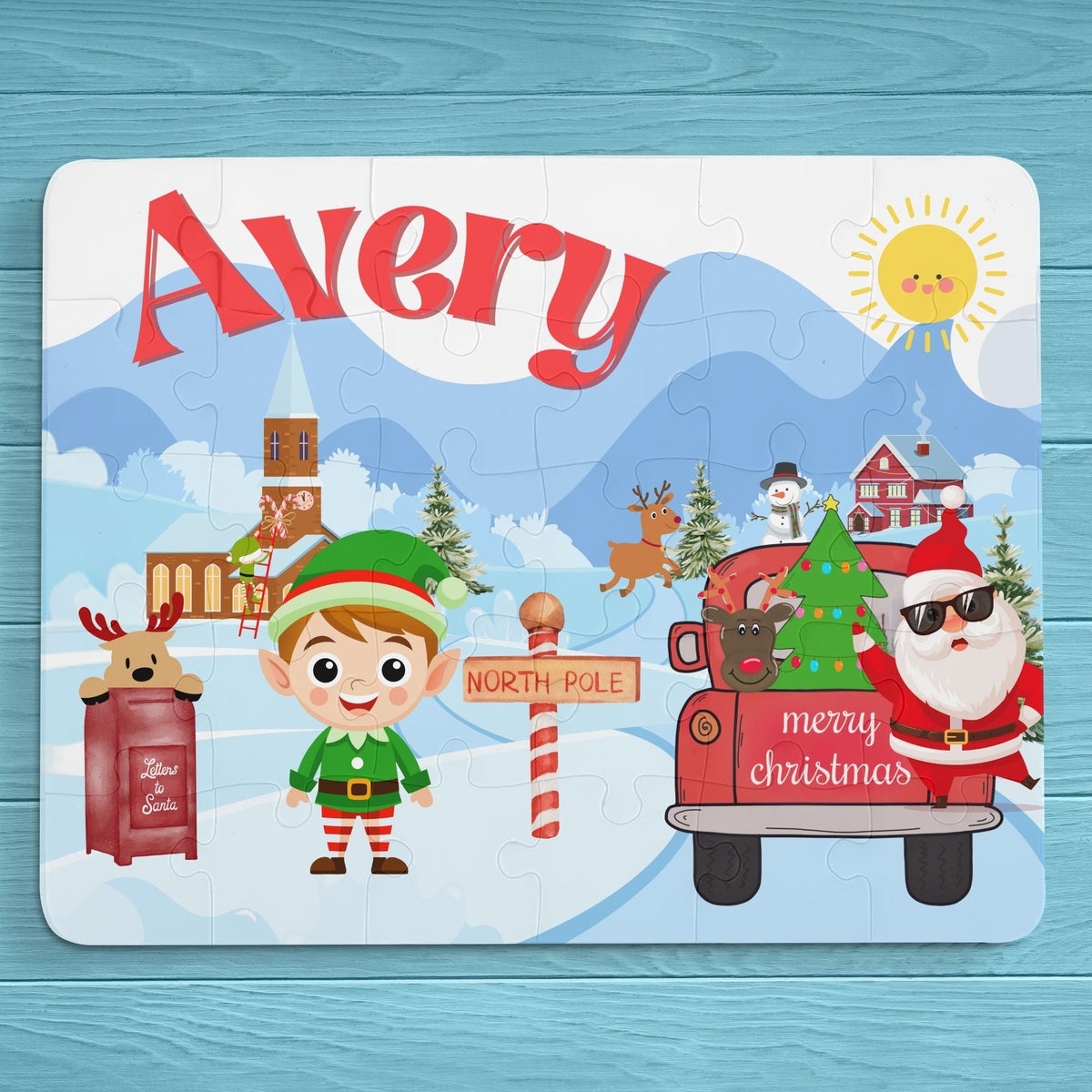 Personalized 30-piece kids Christmas jigsaw puzzle featuring a North Pole village scene with an elf, Santa, reindeer, and winter buildings, with a customizable name displayed across the top of the puzzle.
