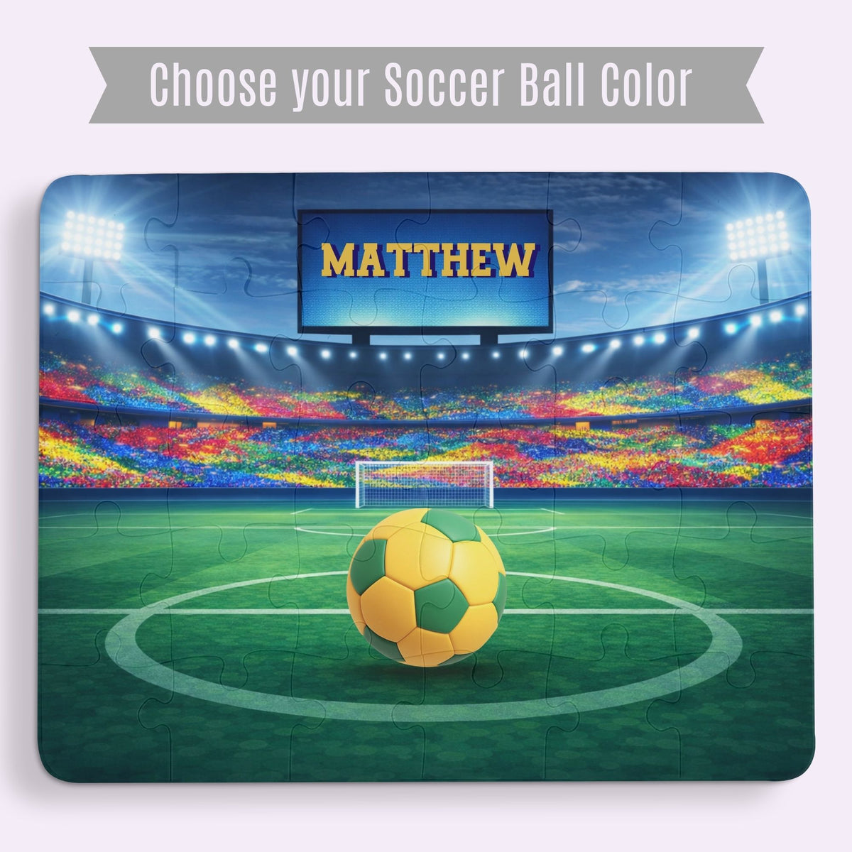 Personalized kids soccer jigsaw puzzle featuring a stadium field scene with a customizable name displayed on the scoreboard above the goal and a selectable soccer ball color centered on the field.