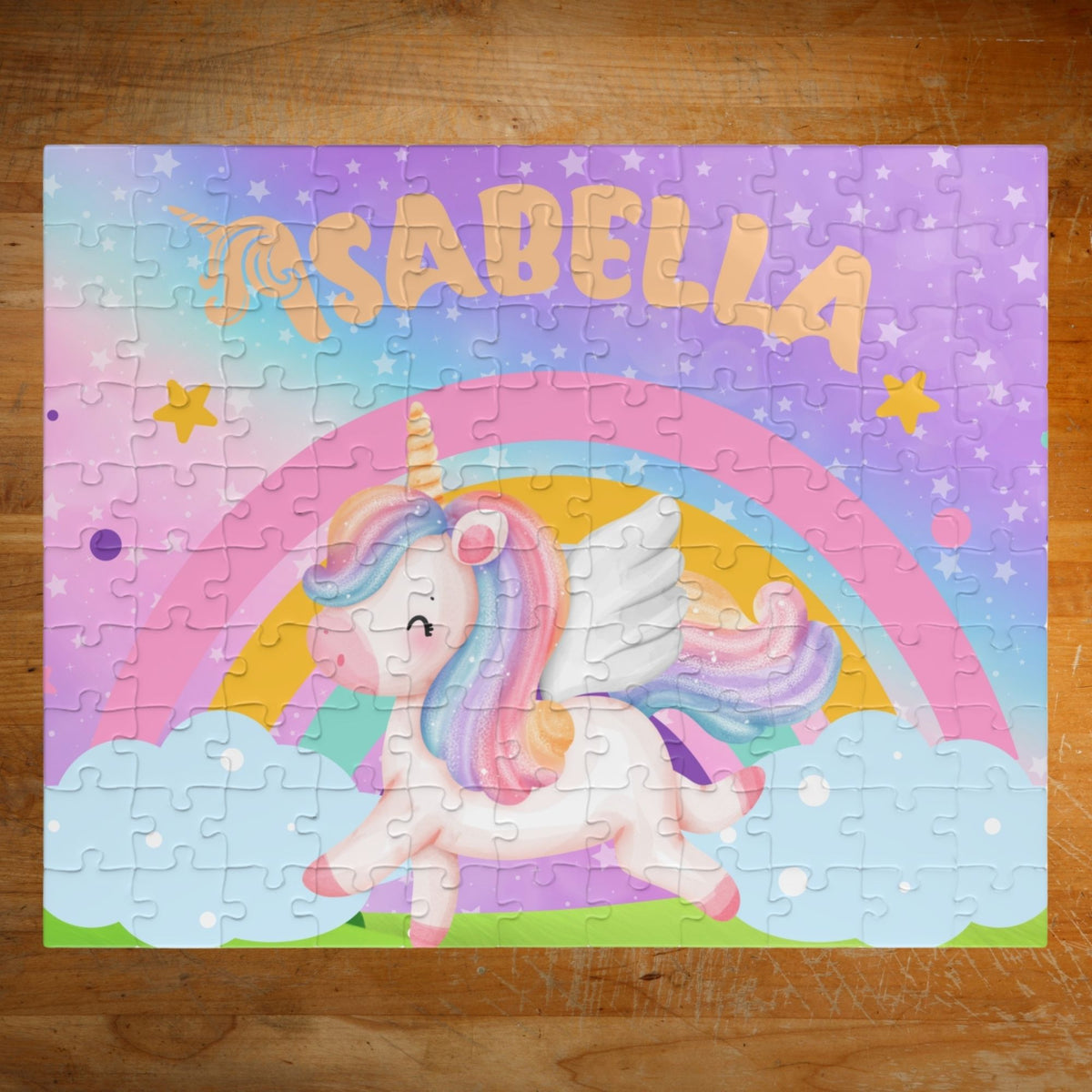 Children's puzzle with a unicorn and rainbow design on a wooden surface