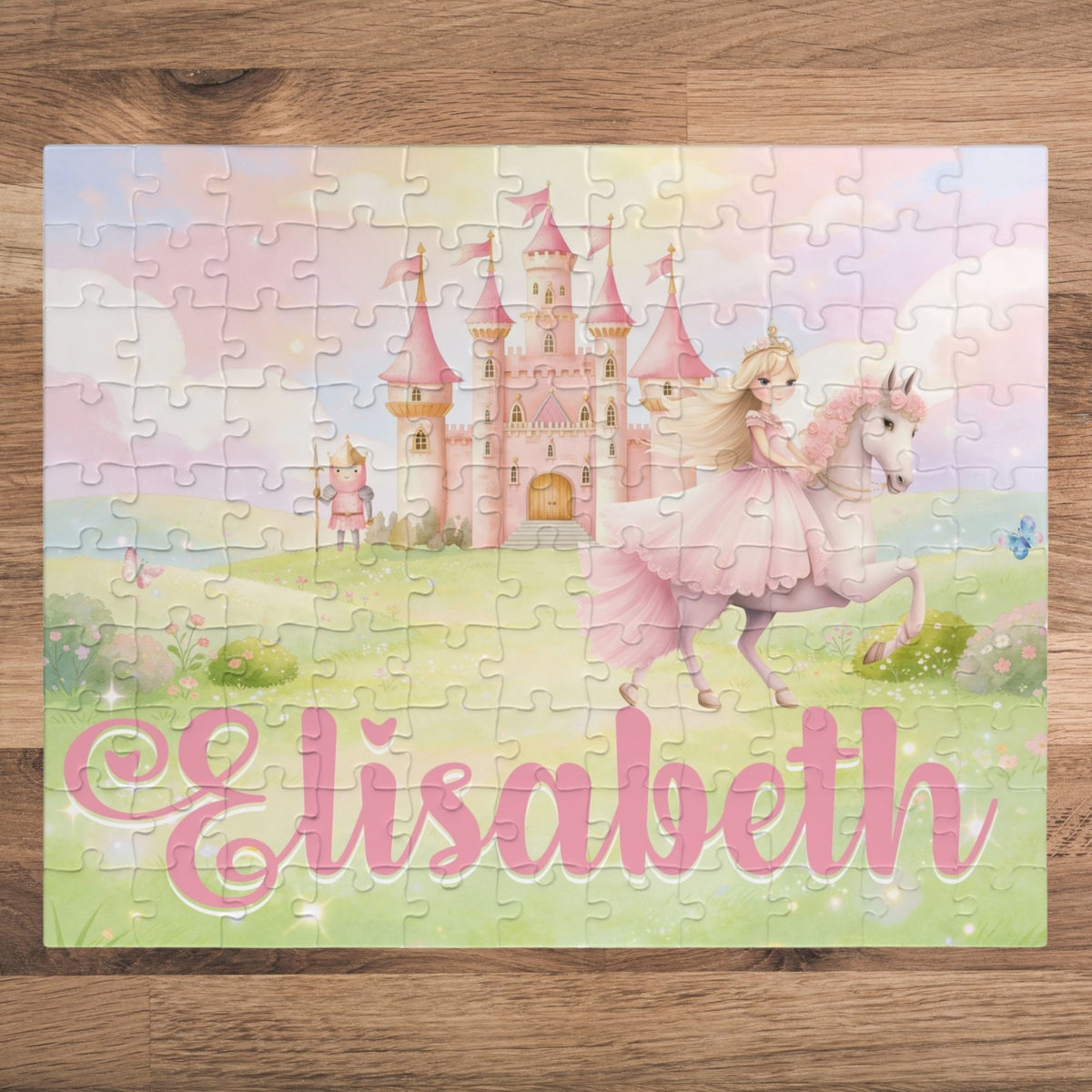 Completed personalized princess puzzle featuring a soft pastel fairytale scene with a princess on horseback, pink castle, flowers, sky, and a customizable child’s name displayed across the bottom.