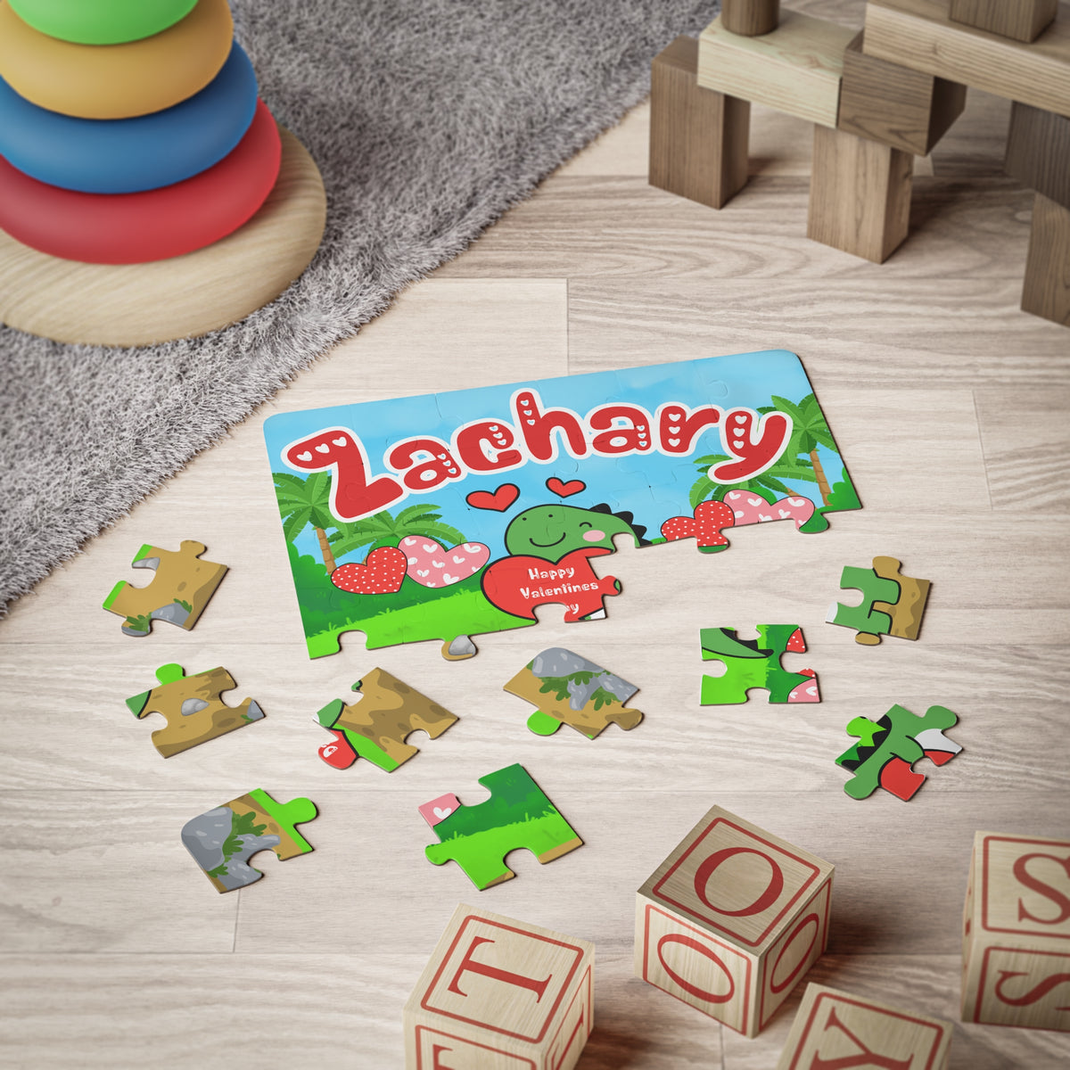 Personalized kids jigsaw puzzle with a colorful dinosaur Valentine’s Day design, featuring a customizable name printed across the top. The puzzle pieces are spread out on the floor to show size, piece shape, and artwork details.