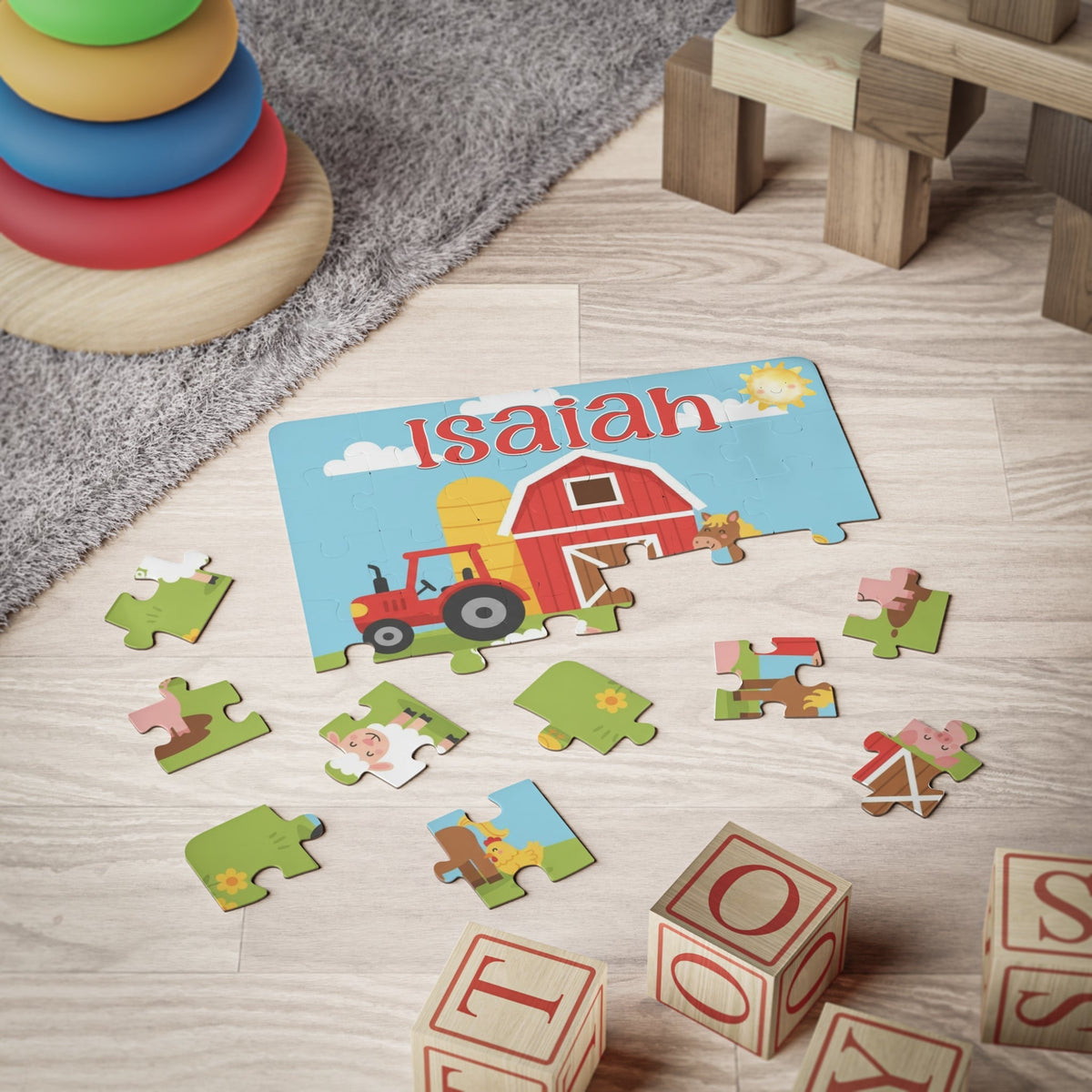 Personalized farm-themed kids puzzle on the floor with scattered jigsaw pieces, showing a barn, tractor, and friendly farm animals, with a customizable name printed across the top.