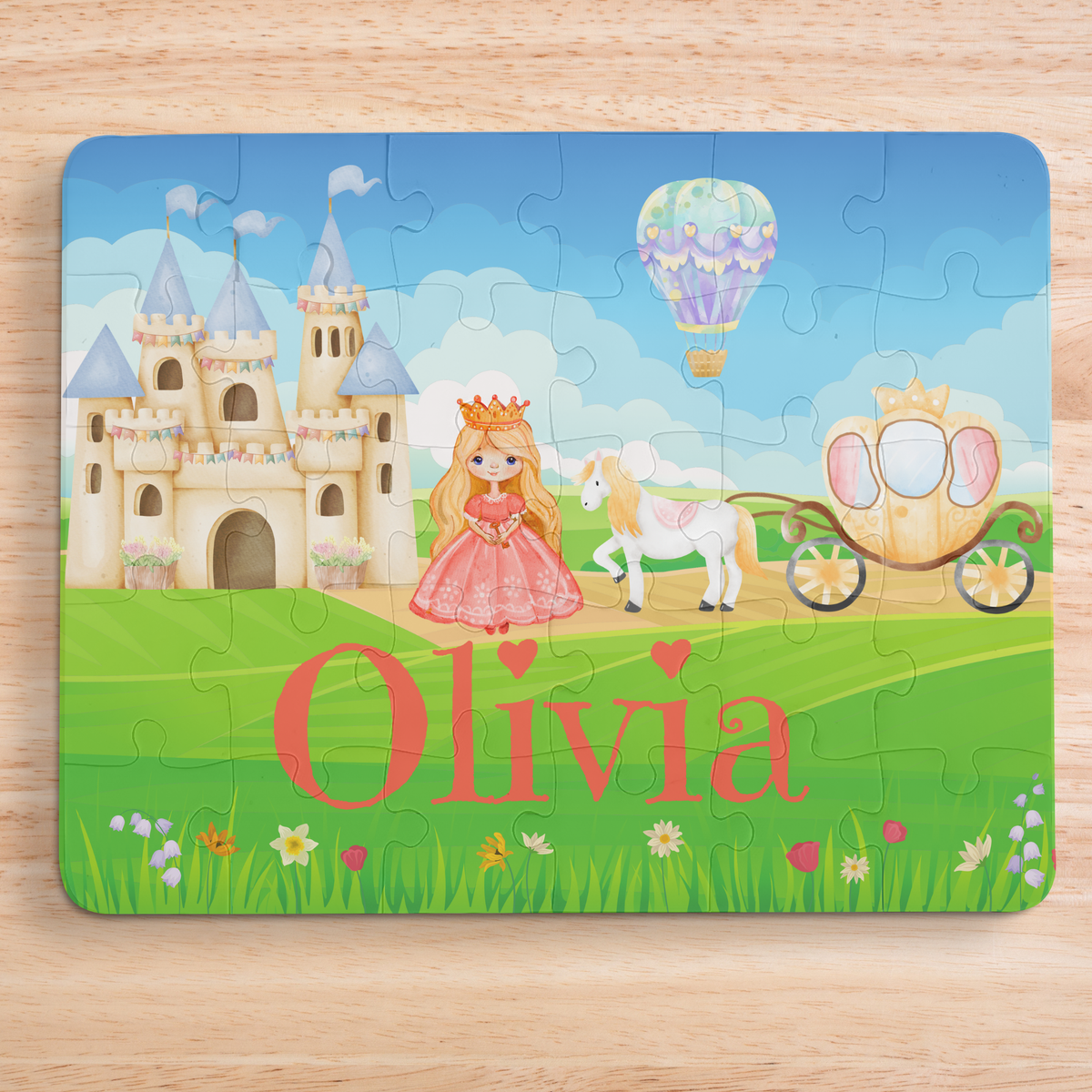 Personalized kids princess jigsaw puzzle with a customizable name displayed across the bottom of the puzzle, featuring a princess, castle, horse carriage, and storybook landscape in a 30-piece format.