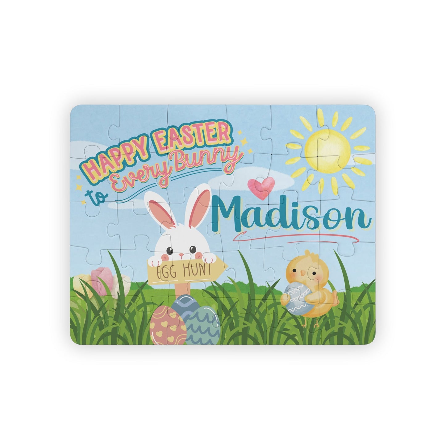 Personalized Easter bunny jigsaw puzzle for kids featuring a spring scene with a bunny holding an egg hunt sign, decorated eggs, and a chick, with a customizable child’s name displayed prominently across the top of the 30-piece puzzle.