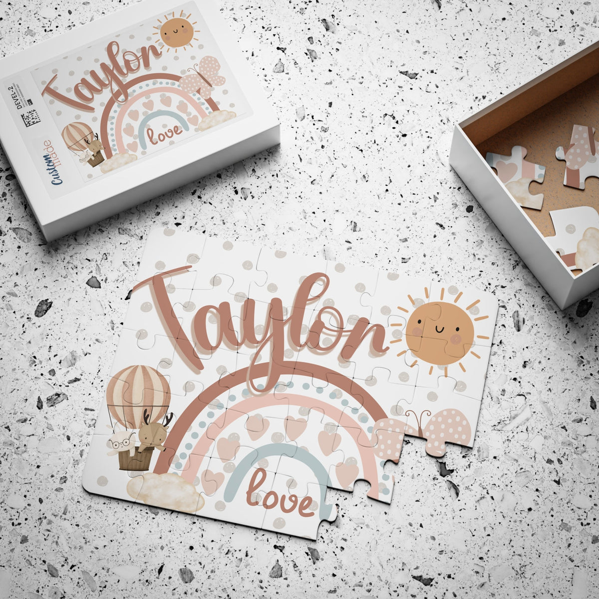 Personalized 30-piece kids jigsaw puzzle featuring a boho rainbow design, with a customizable child’s name displayed across the top of the puzzle and a matching printed box nearby.