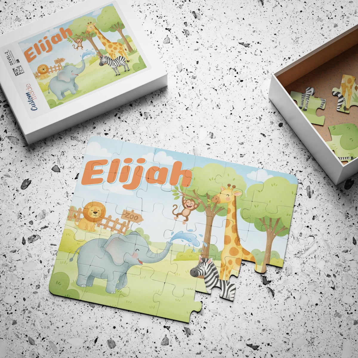 Personalized zoo animal jigsaw puzzle with a customizable name at the top, shown with the matching storage box and loose jigsaw pieces