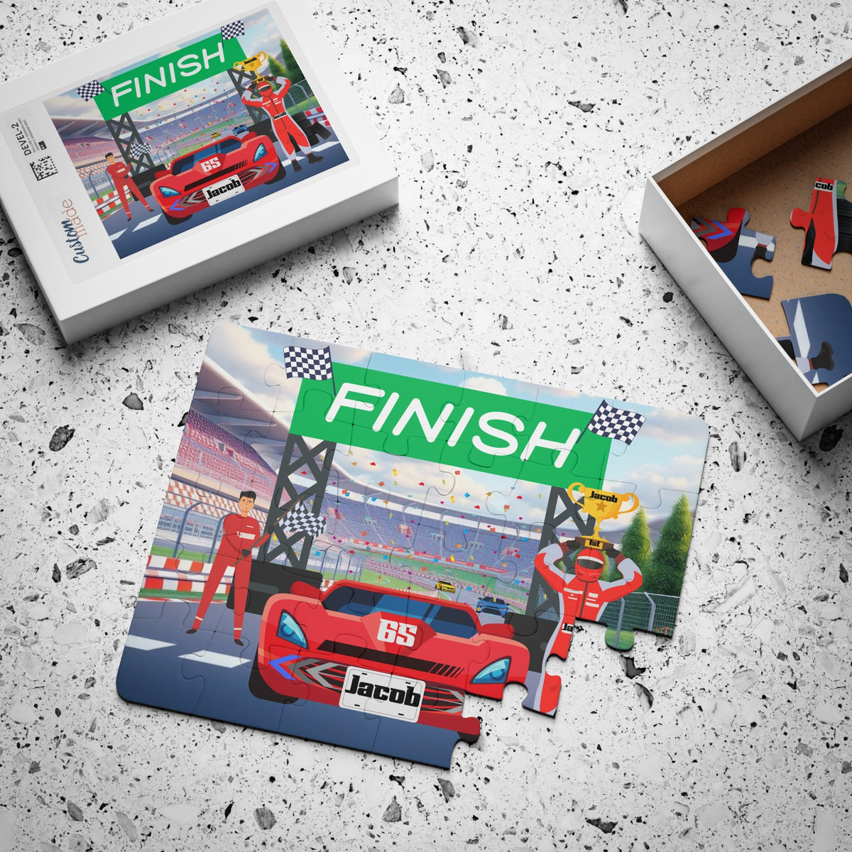Custom racecar jigsaw puzzle for kids shown assembled on a table next to its box, featuring a finish line scene with a trophy and a customizable name displayed on the front of the car.
