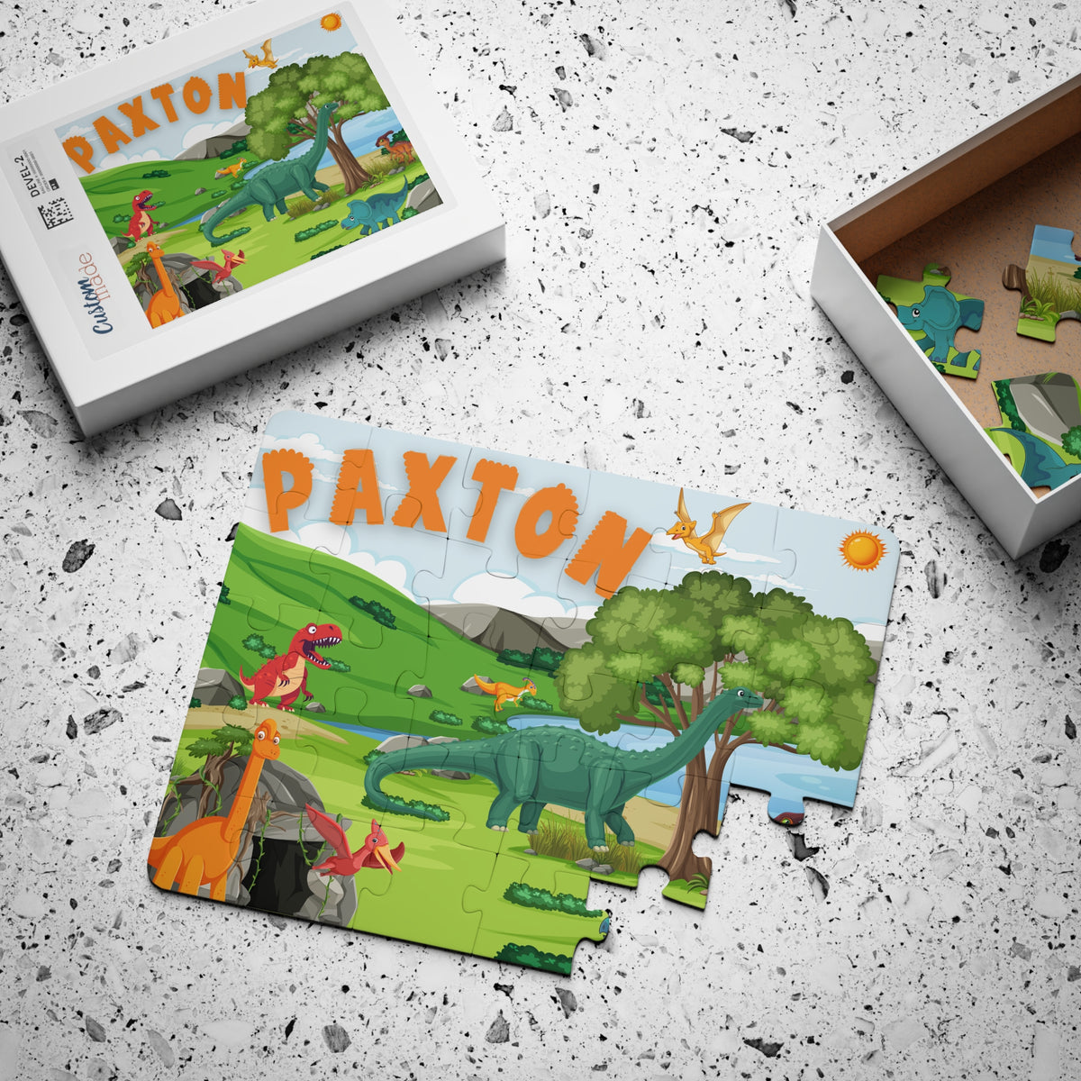 Personalized dinosaur jigsaw puzzle for kids with custom name printed on the design, shown with puzzle pieces and gift box, 30-piece educational toy