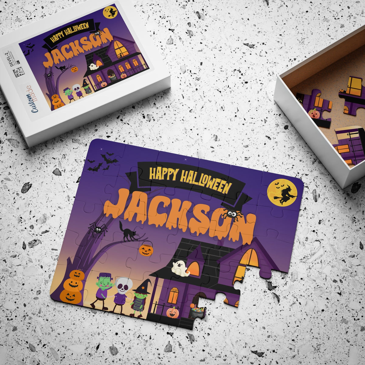 Personalized Halloween kids puzzle displayed next to its box packaging. The 30-piece jigsaw features a spooky haunted house and trick-or-treat scene, with a customizable child’s name printed across the top of the puzzle design.