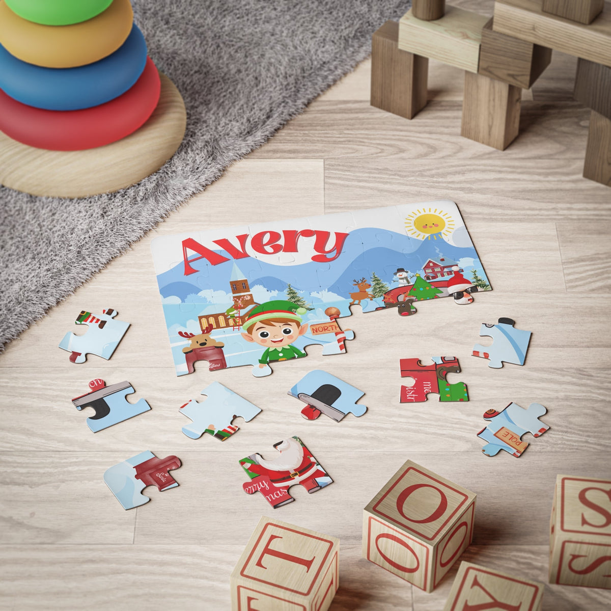 Personalized North Pole Christmas jigsaw puzzle shown partially assembled with loose jigsaw pieces on the floor, displaying a festive winter scene and a customizable name across the top.