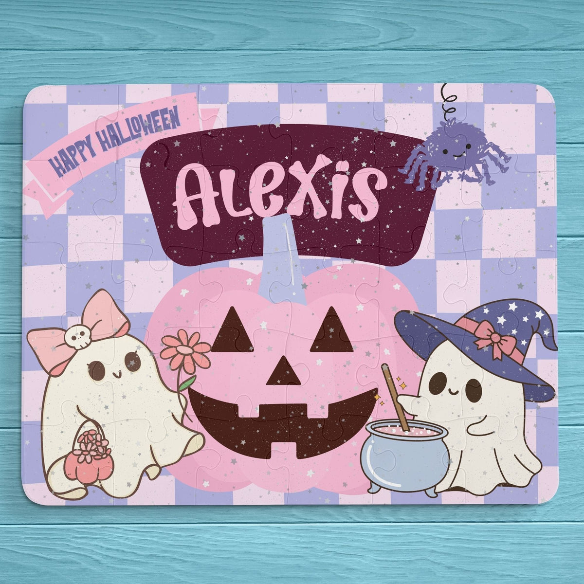Personalized Halloween jigsaw puzzle for kids featuring a customizable name across the top of the puzzle, illustrated with smiling ghosts and a pumpkin, shown fully assembled.