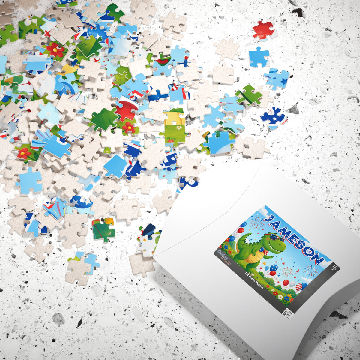Scattered puzzle pieces and packaging displaying a personalized dinosaur puzzle with custom name, patriotic colors, fireworks, and festive 4th of July design.