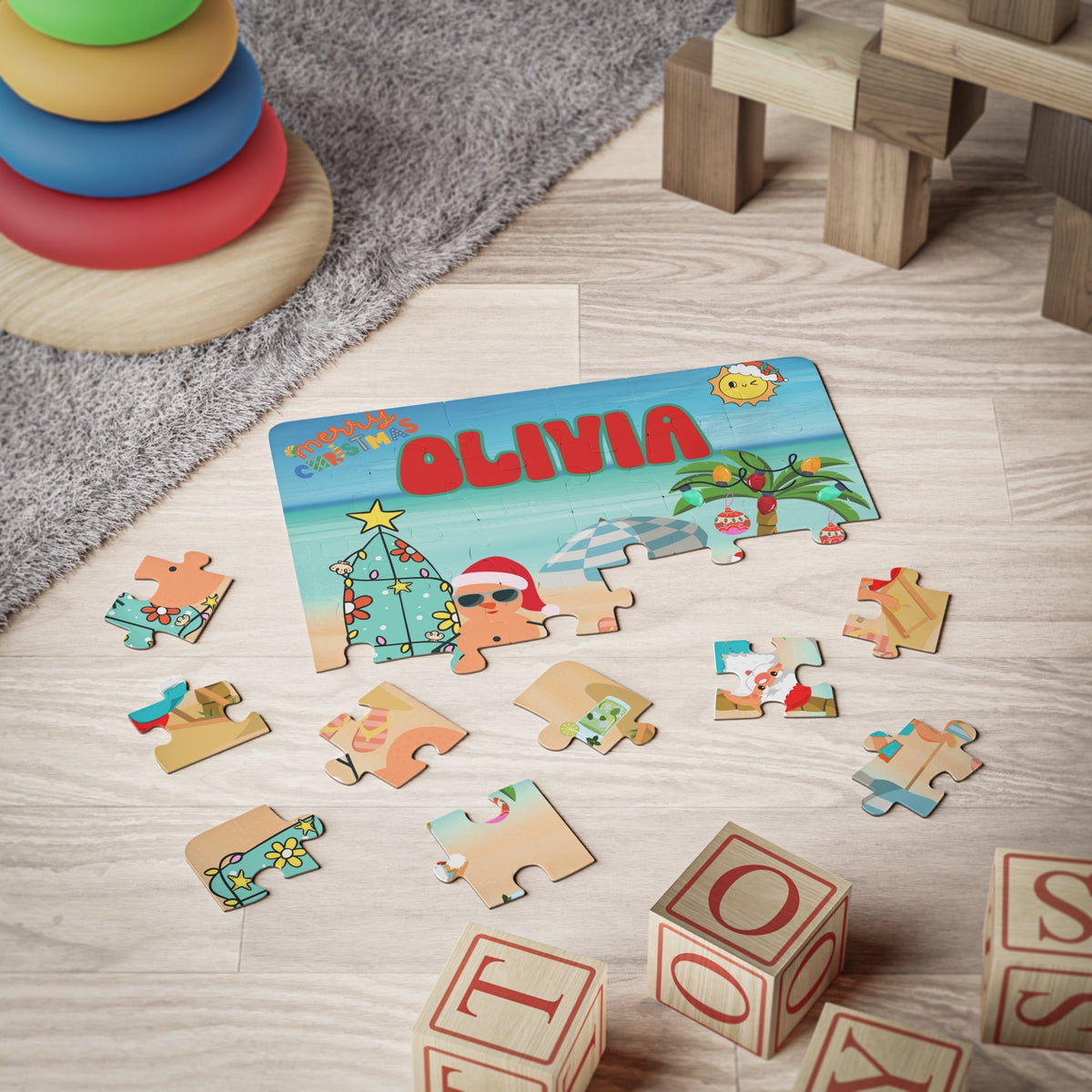 30-piece personalized beach Christmas jigsaw puzzle for kids shown partially assembled with loose pieces around it. The design features Santa at the beach, tropical holiday elements, and a customizable child’s name displayed across the top of the puzzle.