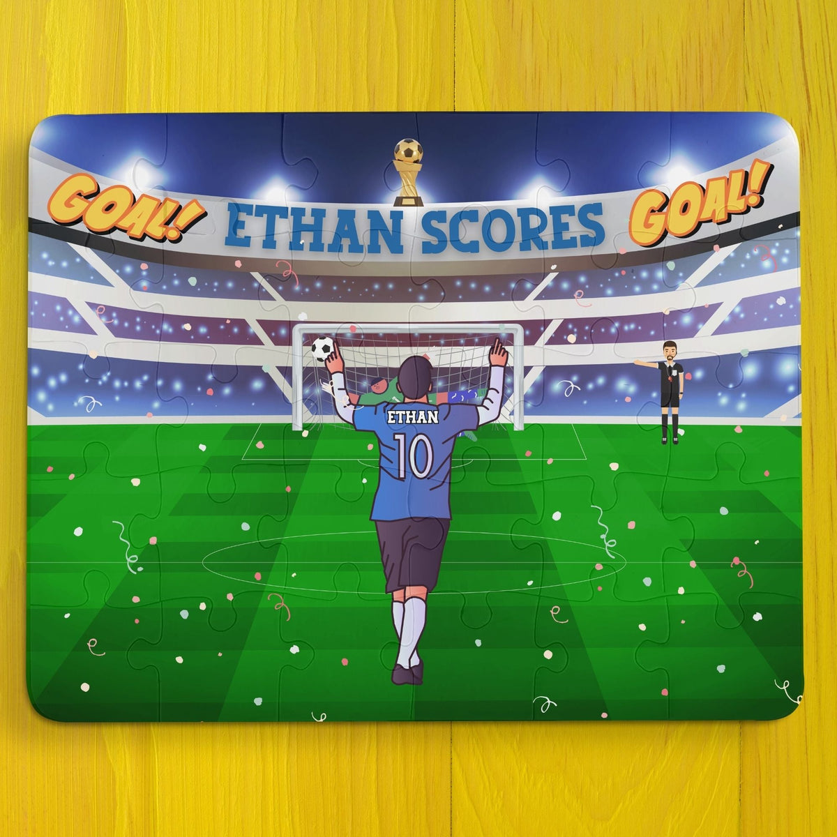 Personalized kids soccer puzzle showing a child scoring a goal in a stadium, with a custom name on the jersey and celebratory scoreboard, 30-piece jigsaw.