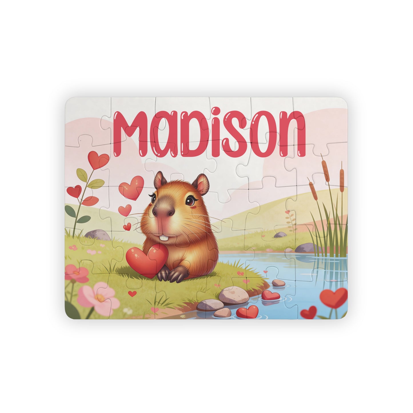 Personalized capybara name puzzle for kids featuring a cute capybara holding hearts in a soft pastel landscape. The child’s name is customizable and appears large across the top of the puzzle (shown as “Madison”), making this a custom 30-piece jigsaw designed for toddlers and young children.