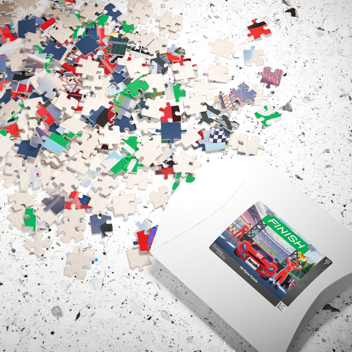 Personalized racecar jigsaw puzzle with loose jigsaw pieces and gift box, featuring a finish line scene and a customizable name printed on the car’s license plate.