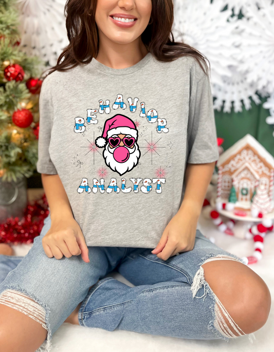 Funny Christmas themed Behavior Analyst Unisex T shirt that features a Santa wearing sunglasses and blowing bubblegum bubbles and says "Behavior Analyst" comes in a variety of sizes and colors