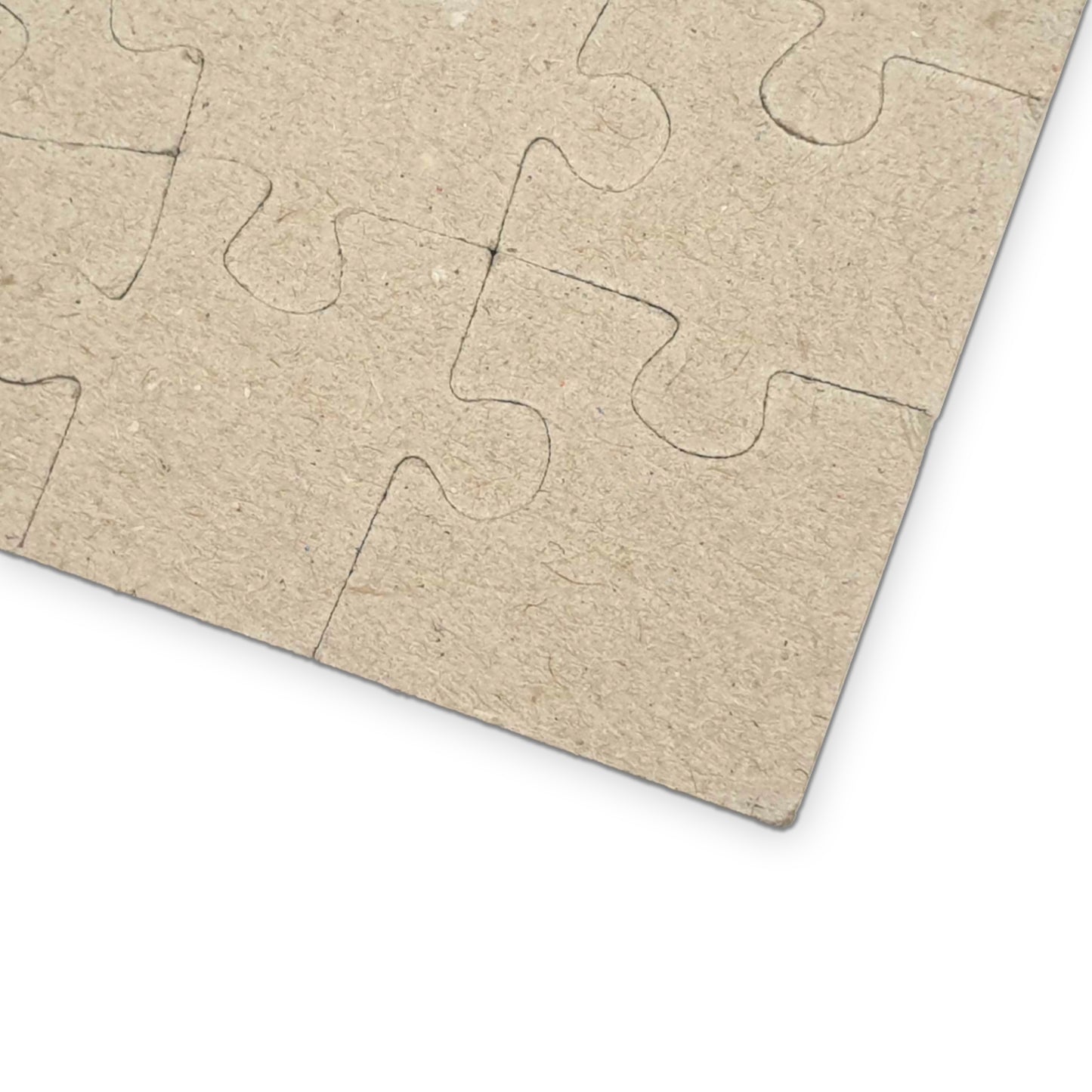 Close-up view of the back of the puzzle showing blank, unprinted jigsaw pieces to highlight the puzzle material and piece shape.