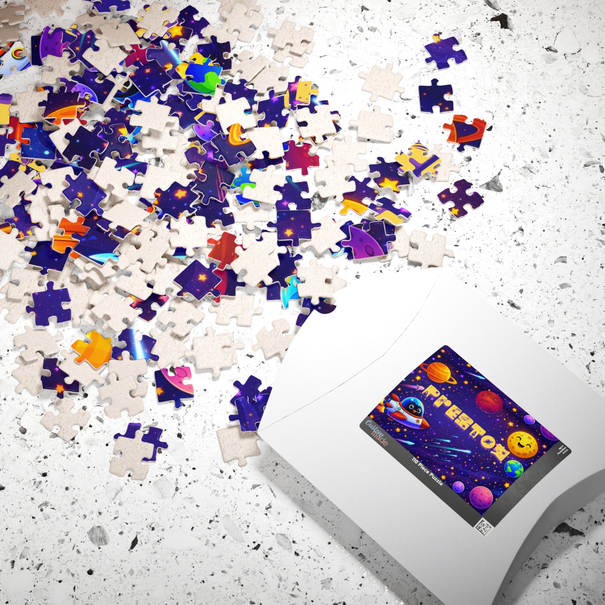 Completed personalized space puzzle with a custom name displayed beside its gift box, featuring planets, stars, rockets, Earth, and a colorful outer space theme for kids.