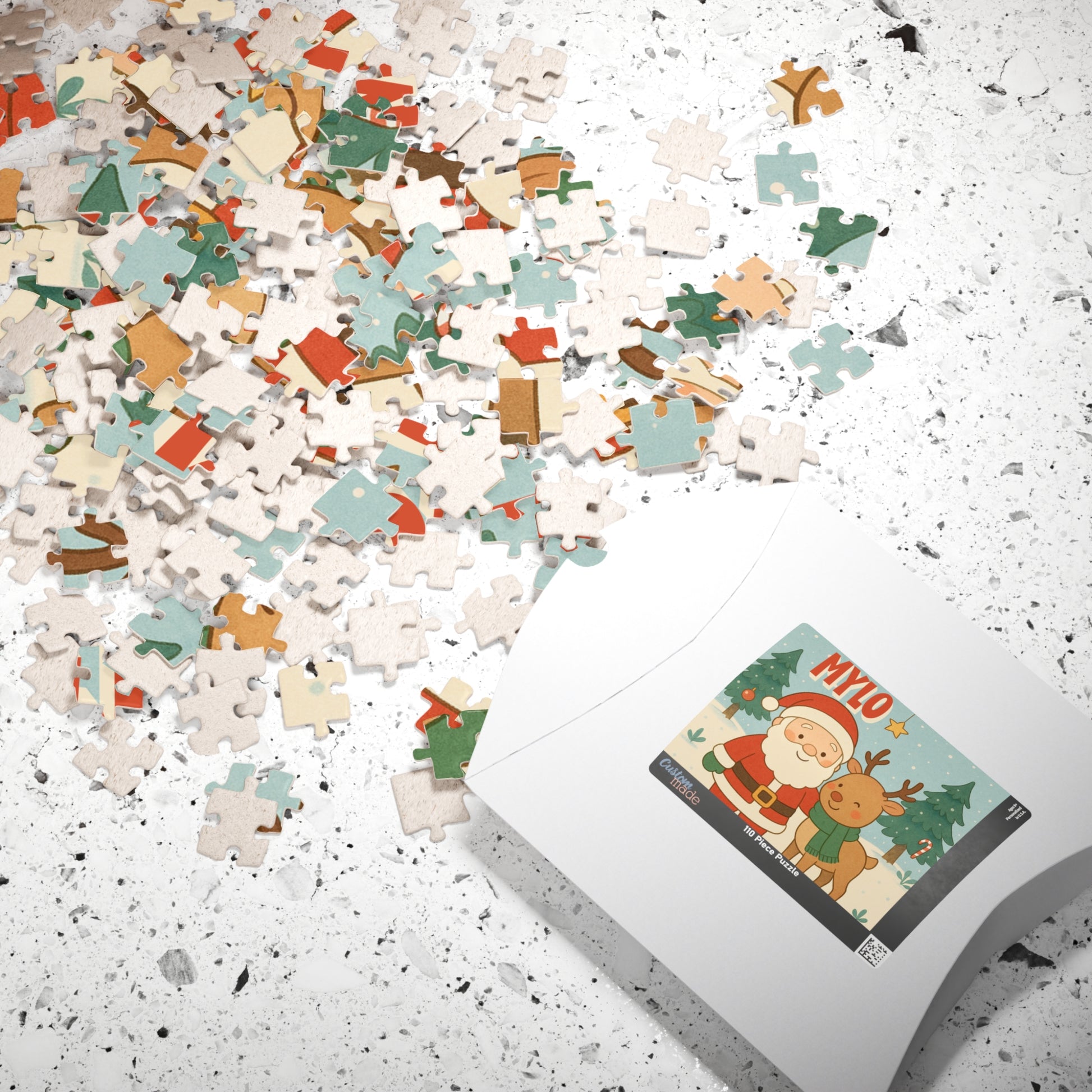 Scattered personalized Christmas puzzle pieces beside the puzzle box featuring a custom Santa and reindeer holiday design.
