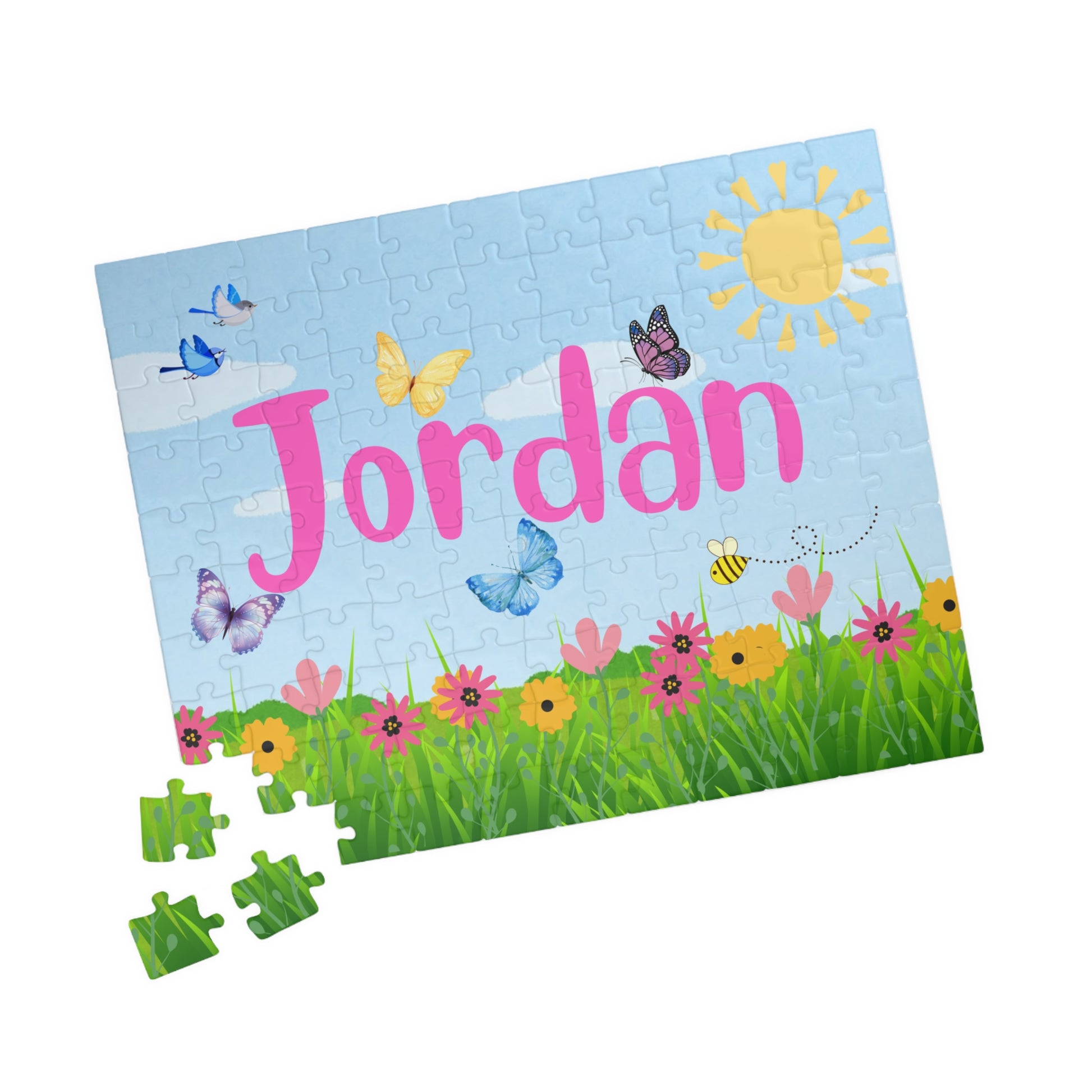 Close-up of scattered 110 piece spring themed jigsaw puzzle pieces showing colorful floral and sky artwork, personalized puzzle with a custom name 