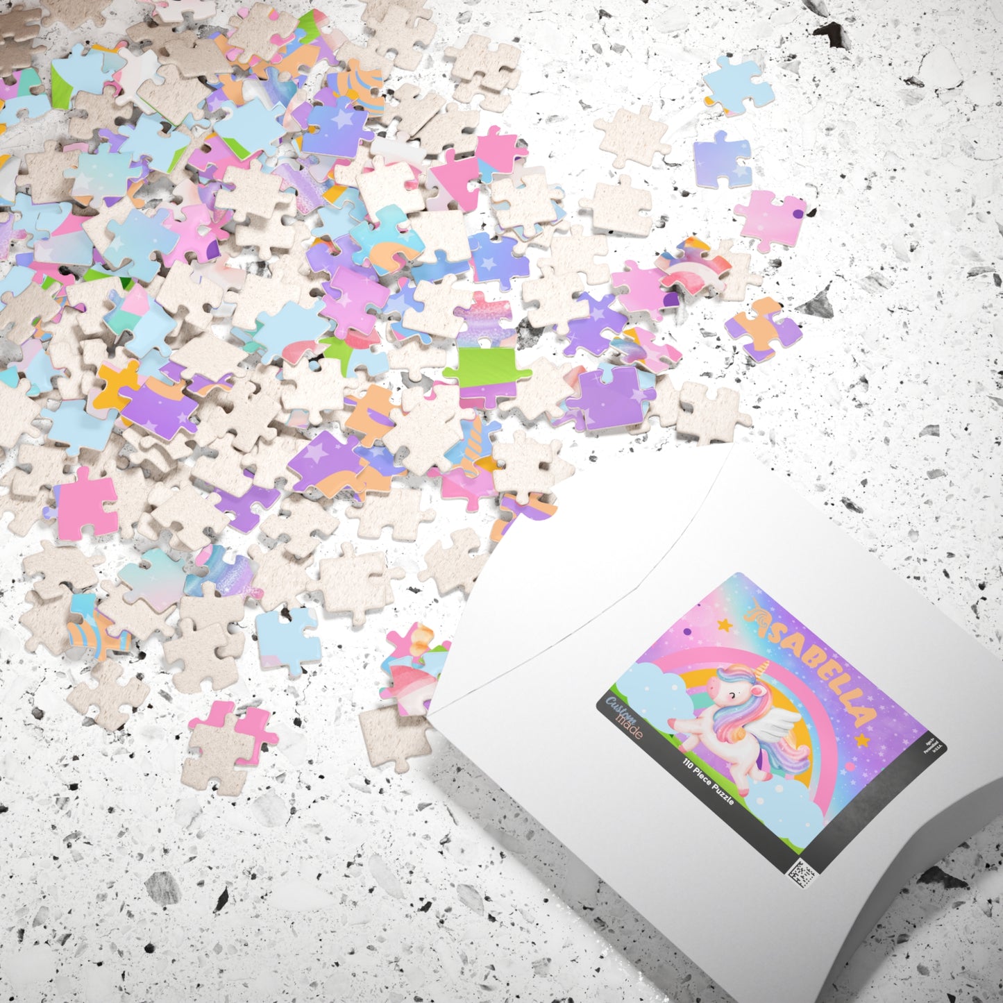Personalized unicorn puzzle shown with packaged in a box and scattered puzzle pieces with the customizable child’s name 