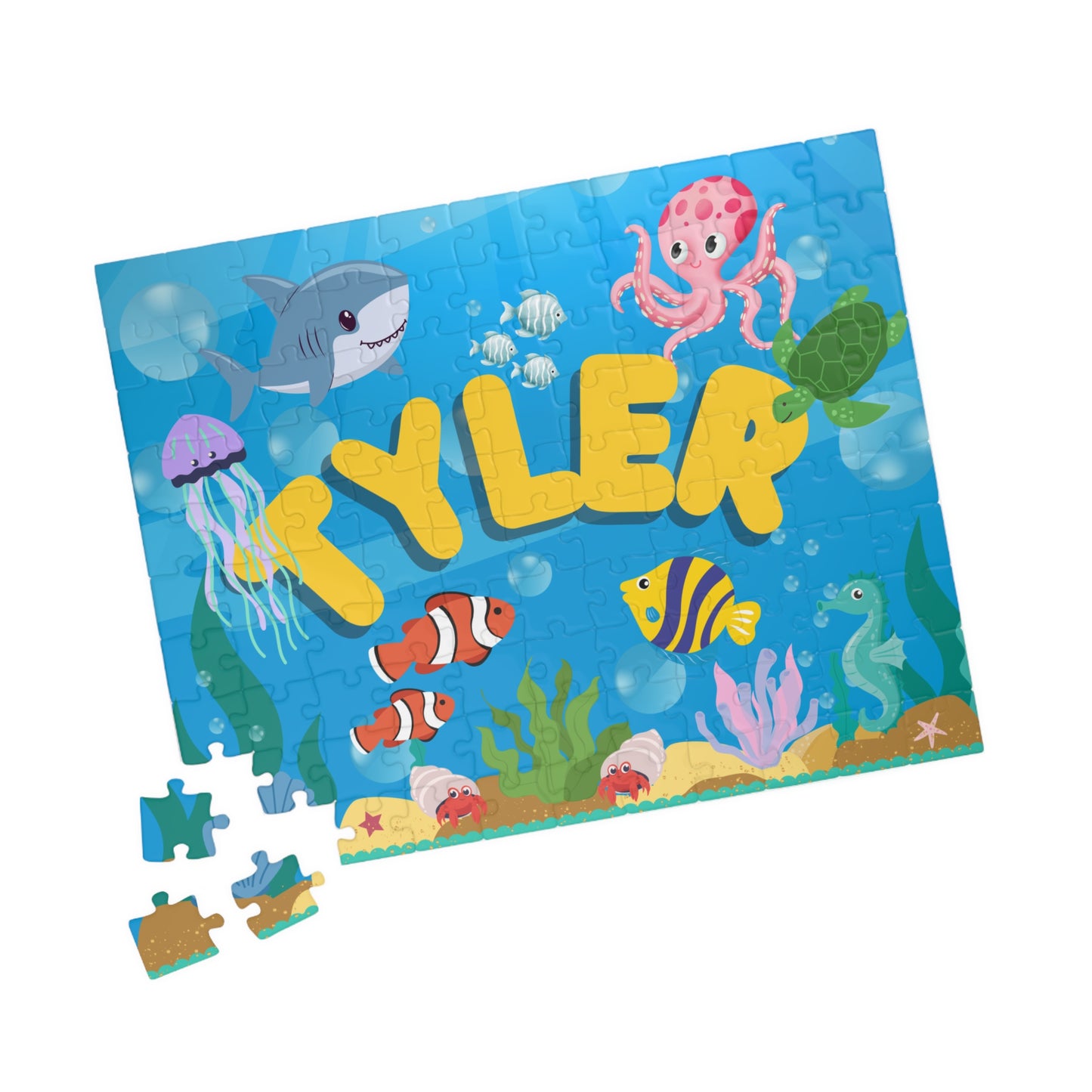 Close-up of scattered jigsaw pieces from a personalized ocean puzzle showing colorful underwater artwork and sturdy puzzle pieces.