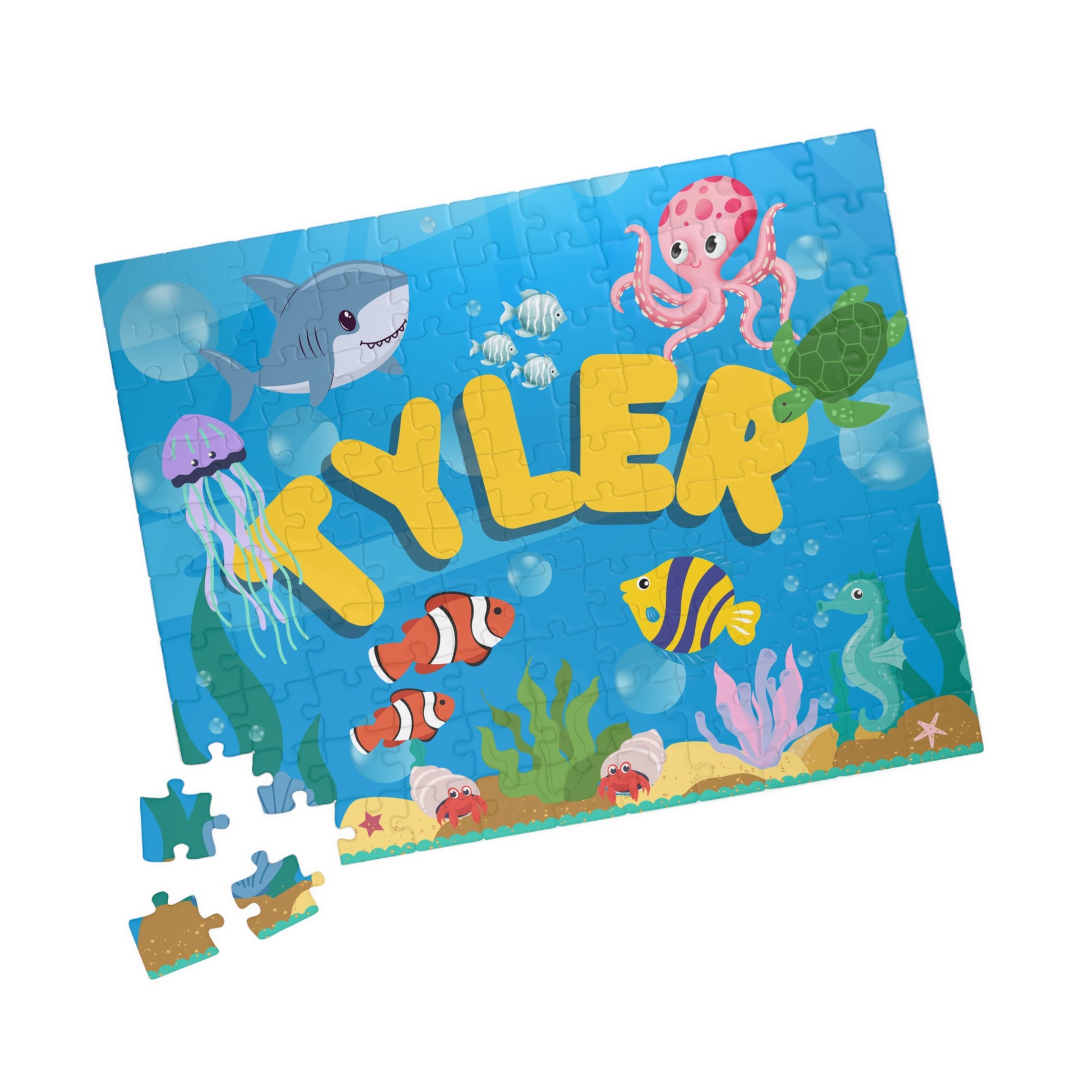 Close-up of scattered jigsaw pieces from a personalized ocean puzzle showing colorful underwater artwork and sturdy puzzle pieces.