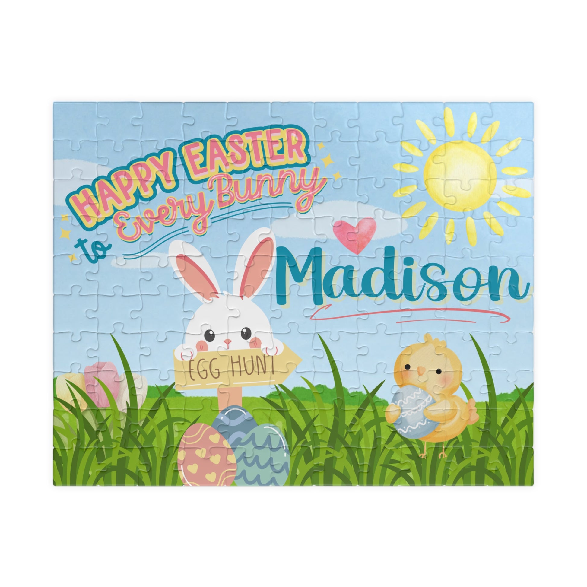 Personalized Easter-themed 110-piece jigsaw puzzle featuring a spring scene with a bunny, chick, pastel eggs, green grass, and sunshine. A customizable name appears across the center of the puzzle design.