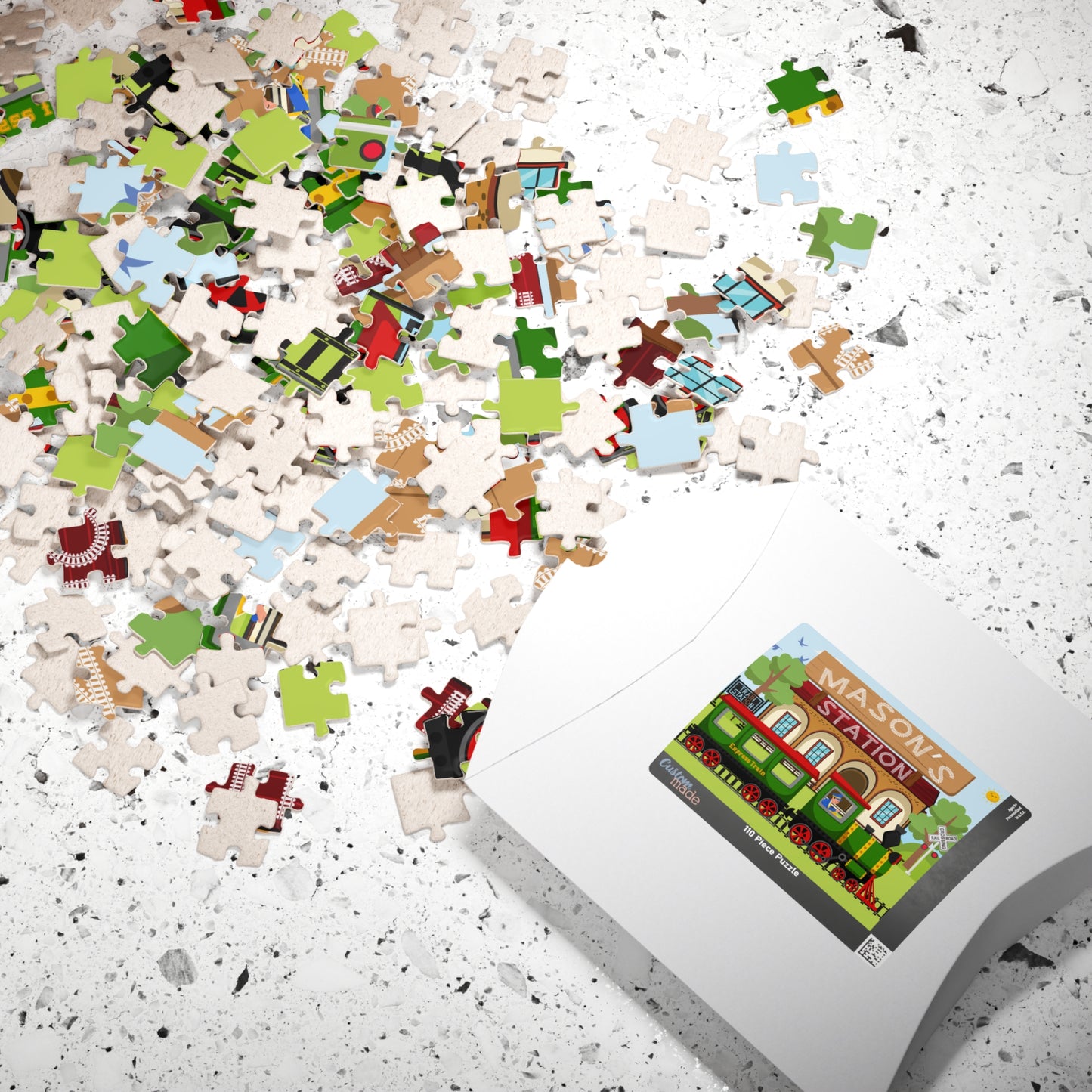 Personalized train station name puzzle shown with puzzle pieces and box, featuring a customizable name on the design
