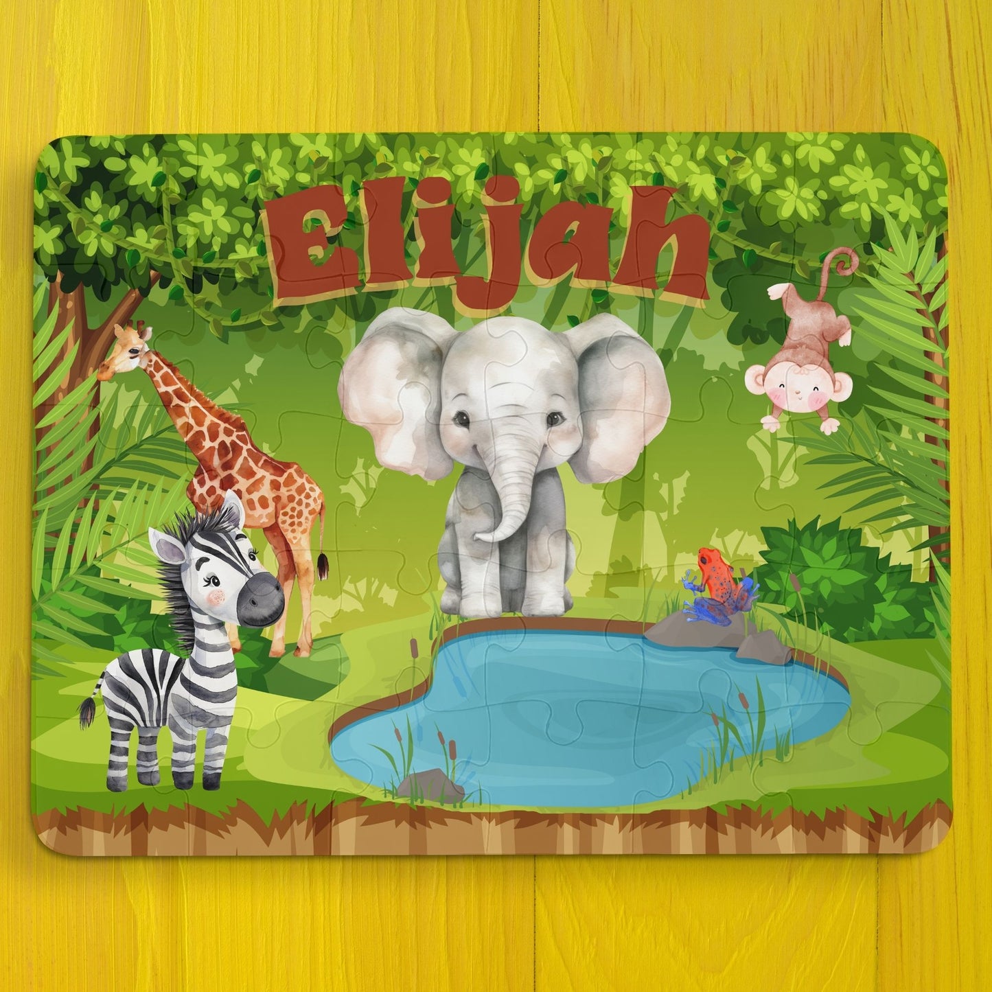 Personalized jungle animal name puzzle with elephant, giraffe, zebra, and monkey illustrations, featuring a customizable child’s name printed across the top of the 30-piece jigsaw puzzle.