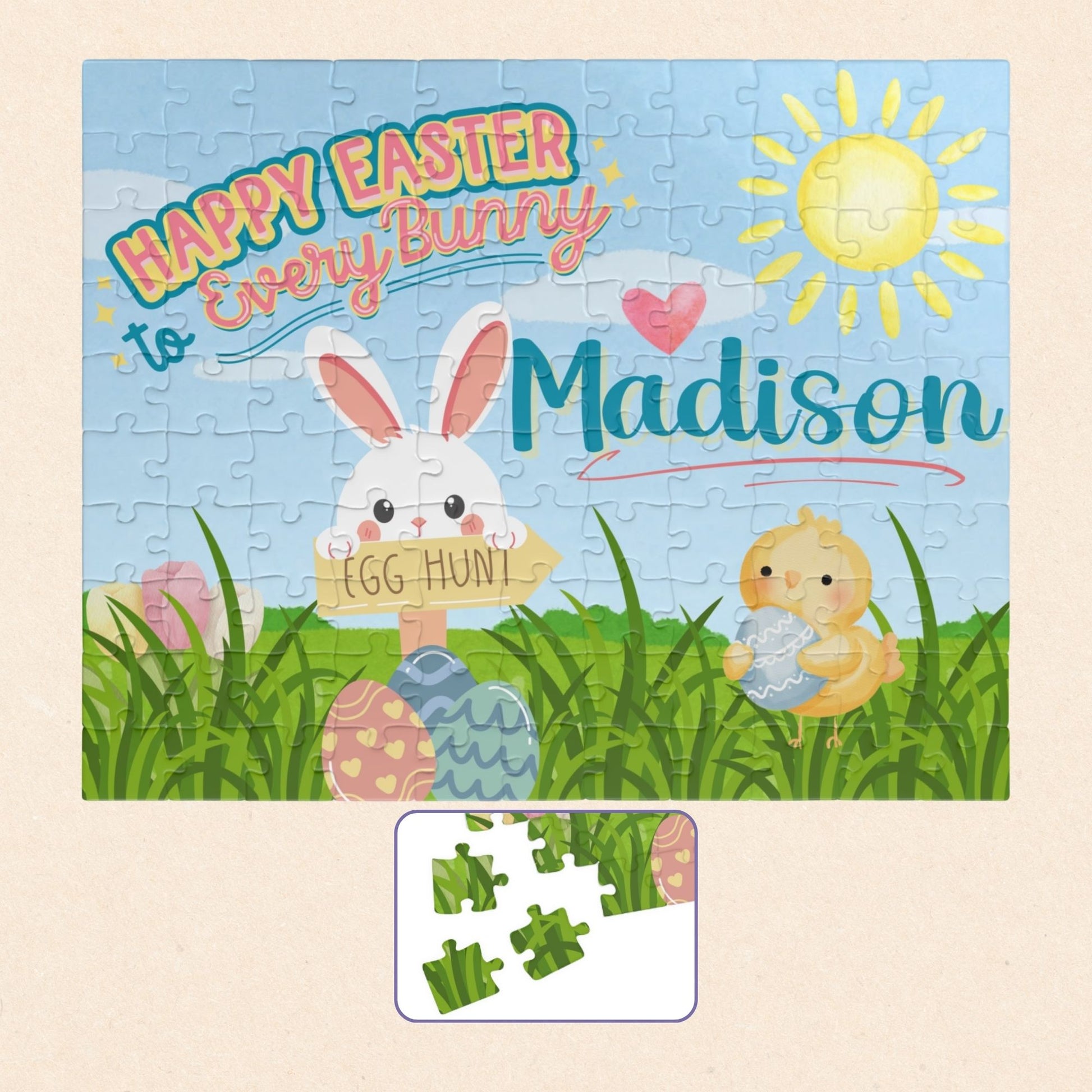 Personalized Easter-themed 110-piece jigsaw puzzle featuring a spring scene with a bunny, chick, pastel eggs, green grass, and sunshine. A customizable name appears across the center of the puzzle design.
